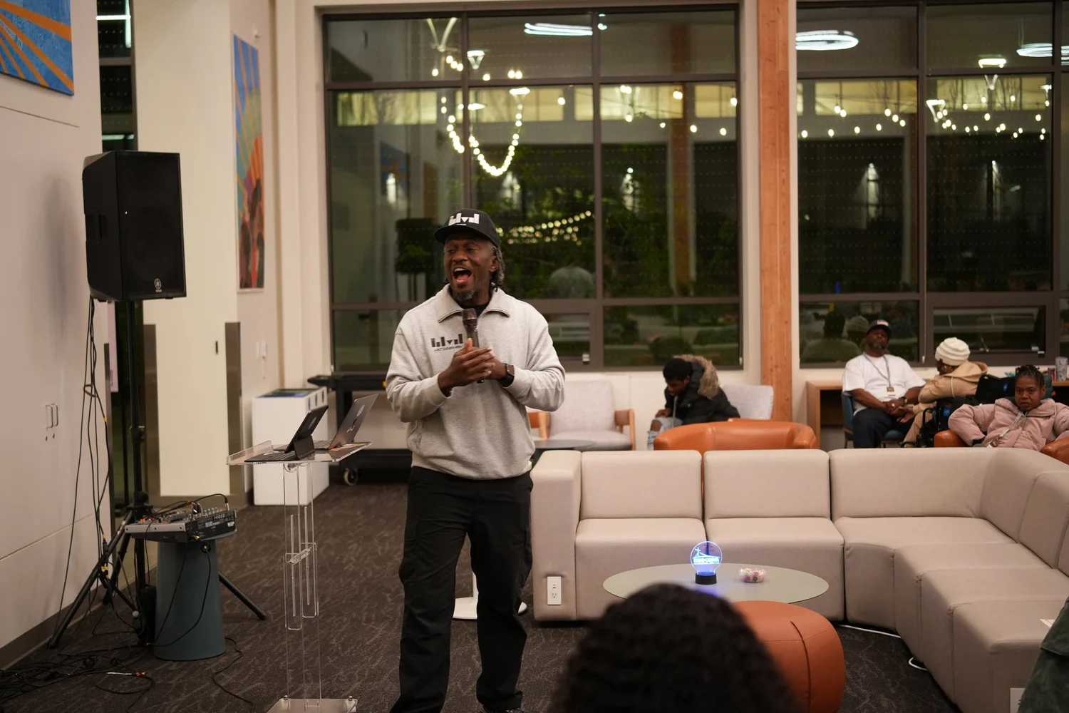 Speaker addressing attendees from the front of the lounge.