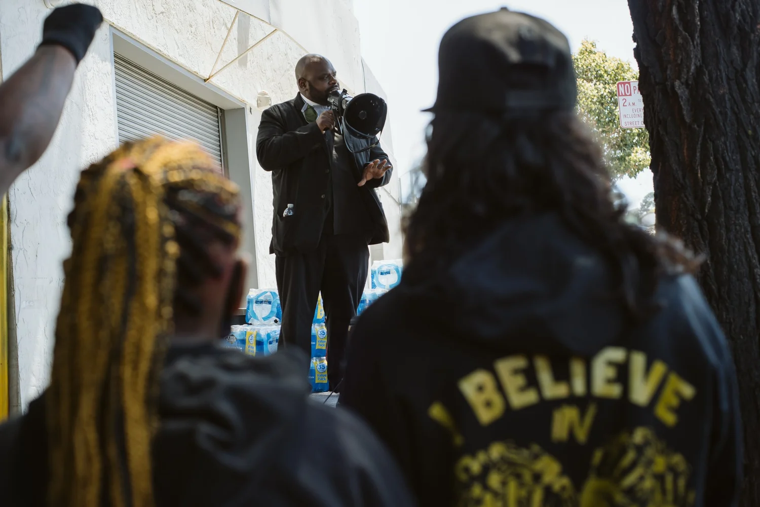 Rally speaker addressing the crowd through a megaphone.