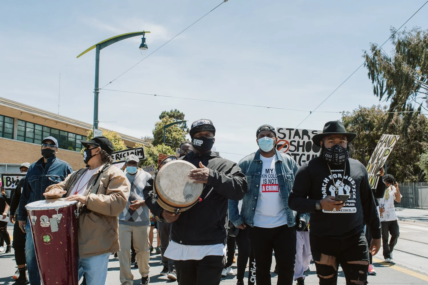 Participants playing hand drums at the rally.