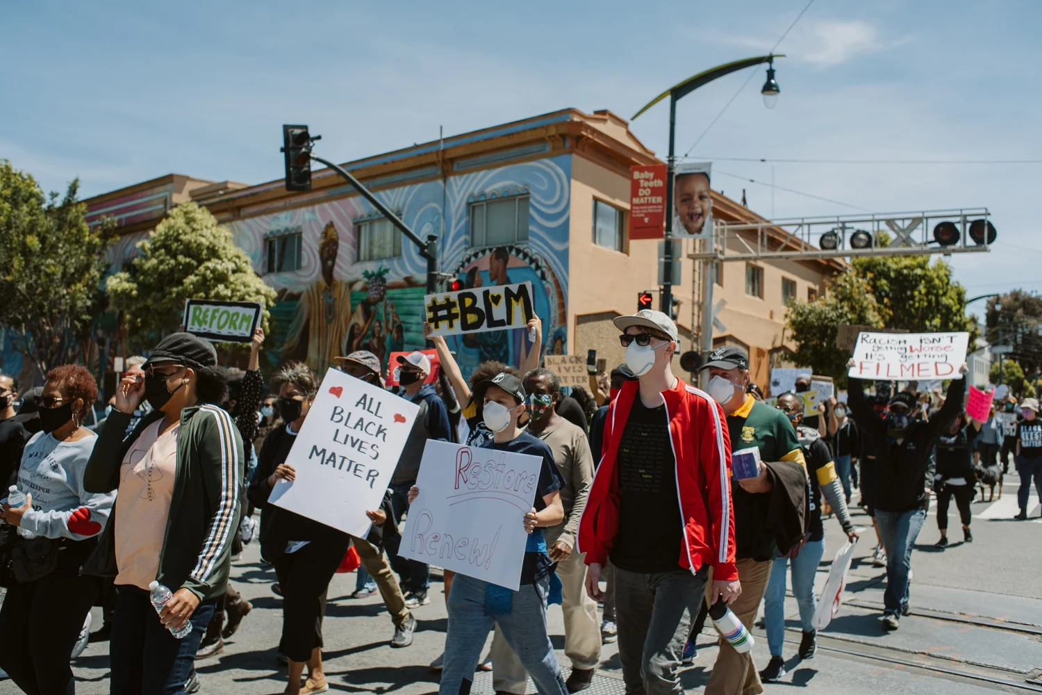 Marchers passing the camera with handmade signs.