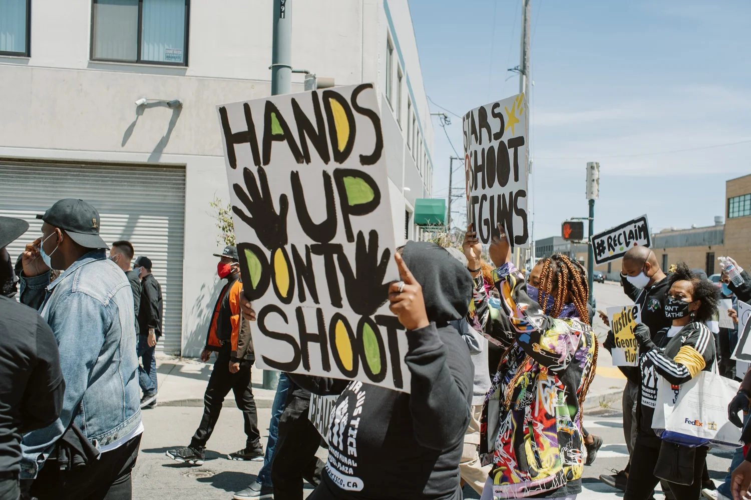 Marcher carrying a Hands Up Don't Shoot sign.