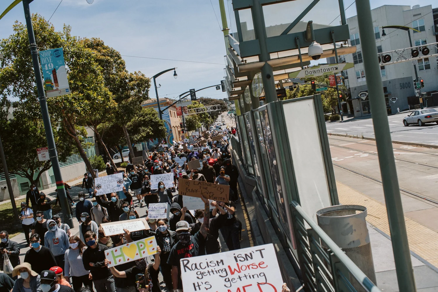 Elevated view of a dense crowd carrying protest signs.