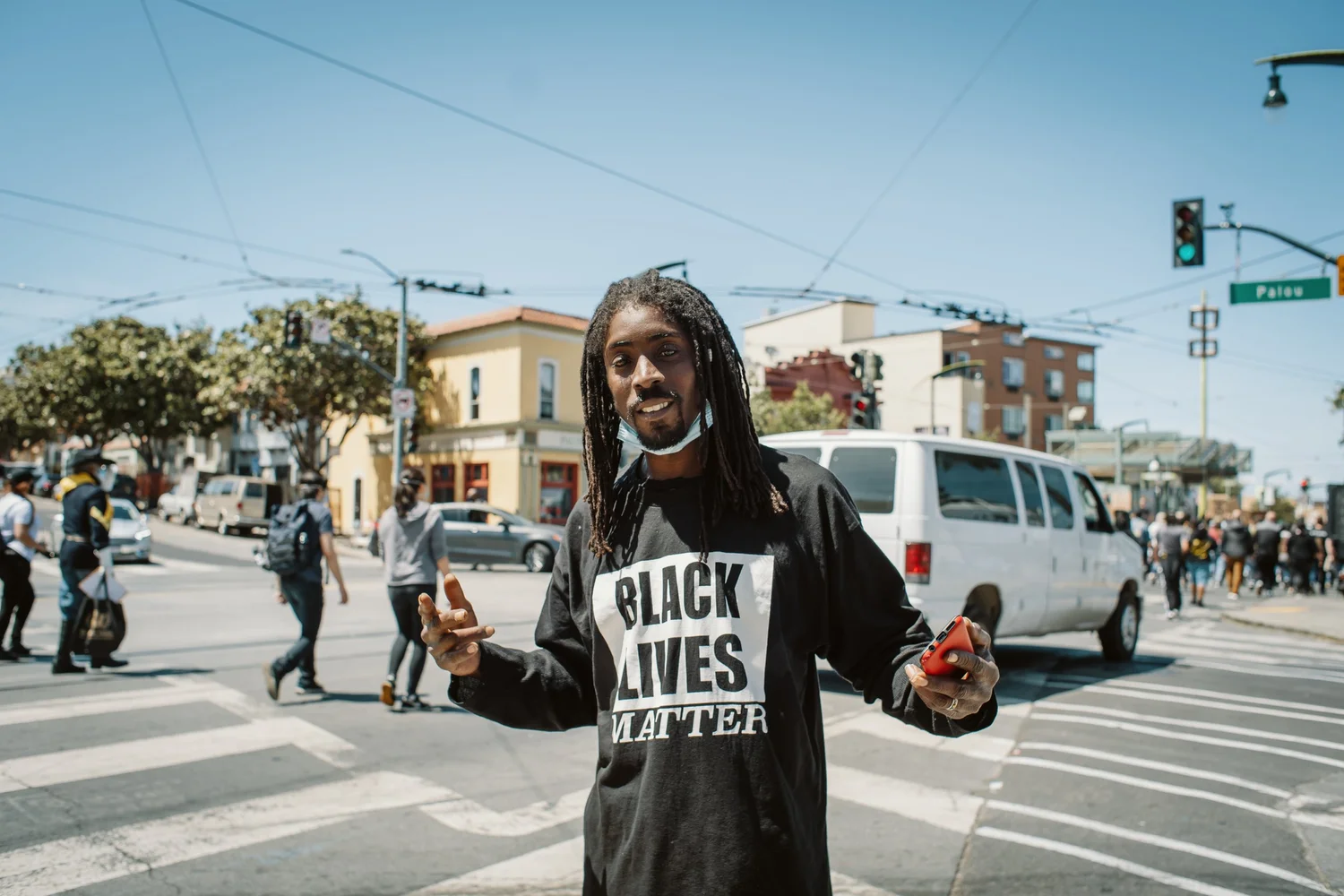 Participant wearing a Black Lives Matter shirt gesturing toward the camera.