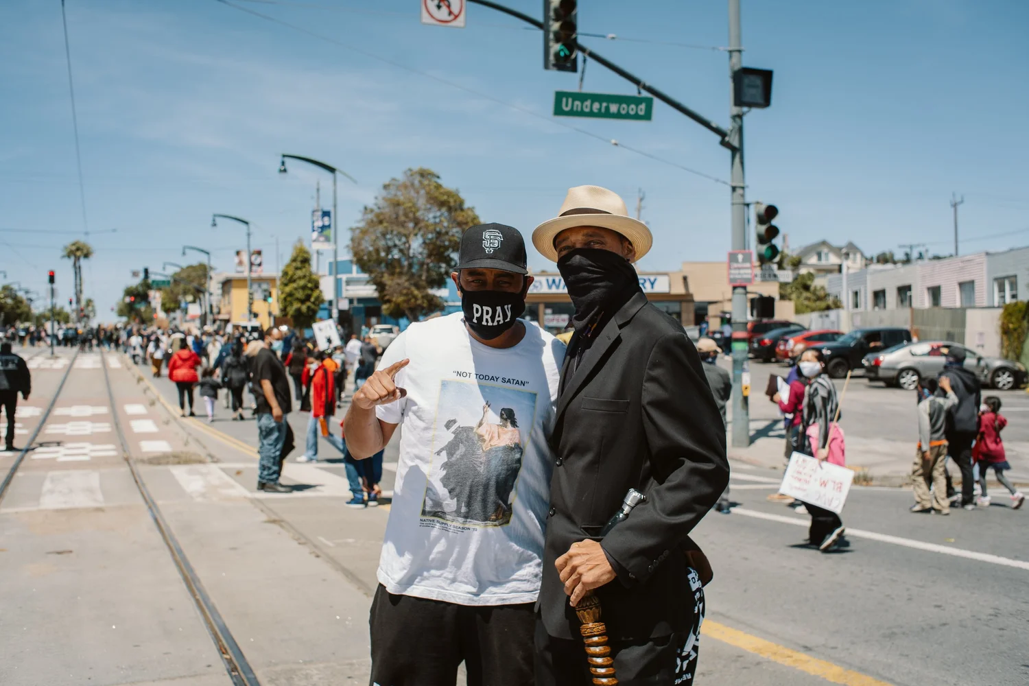 Close view of two masked participants at an intersection.