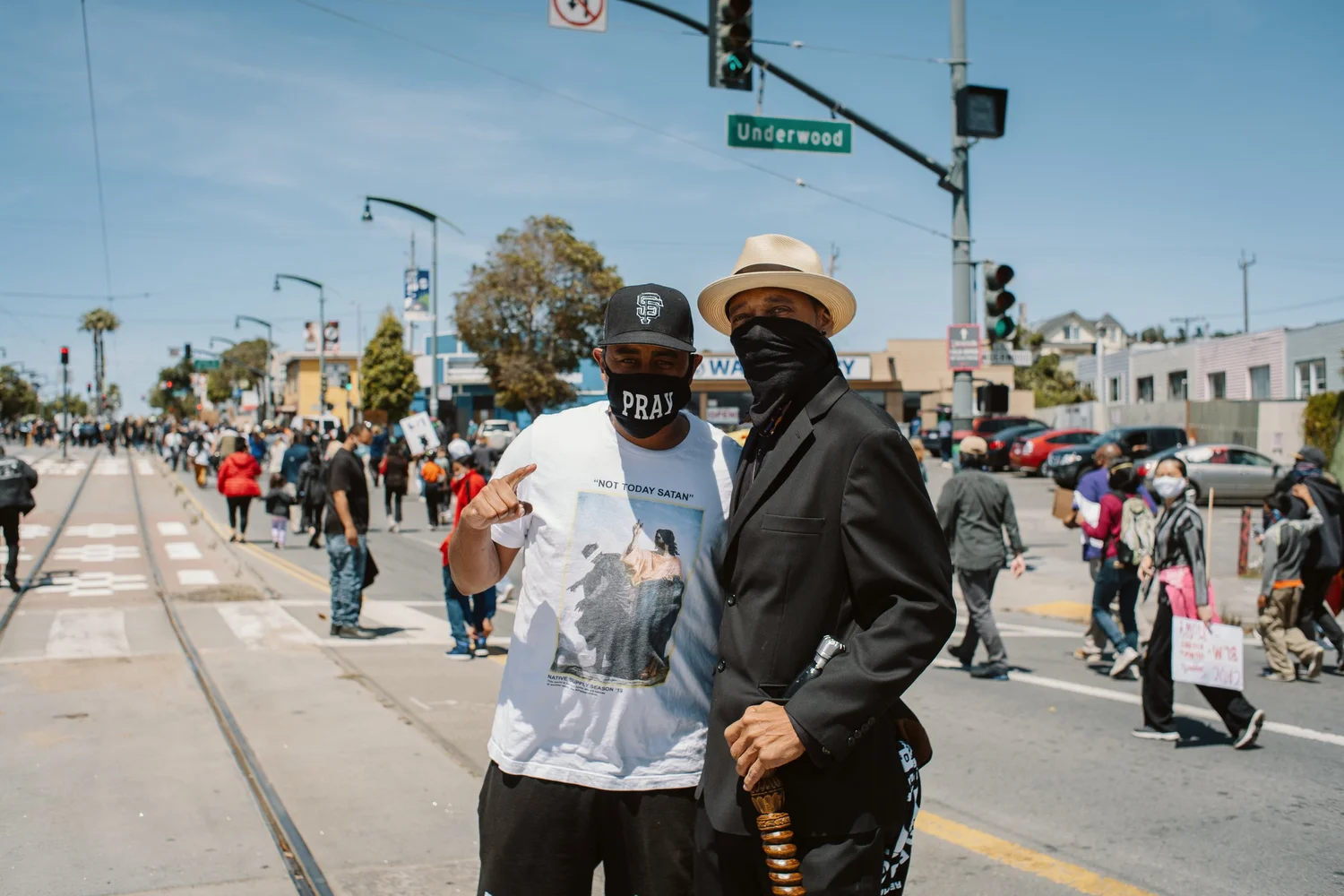 Two participants posing together beside the procession.