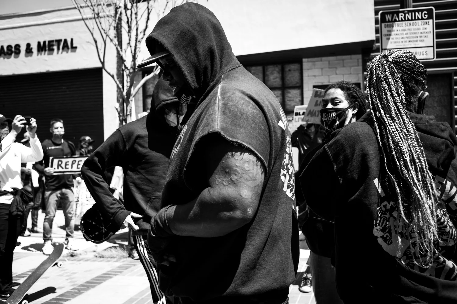 Black-and-white close view of participants wearing hoodies.