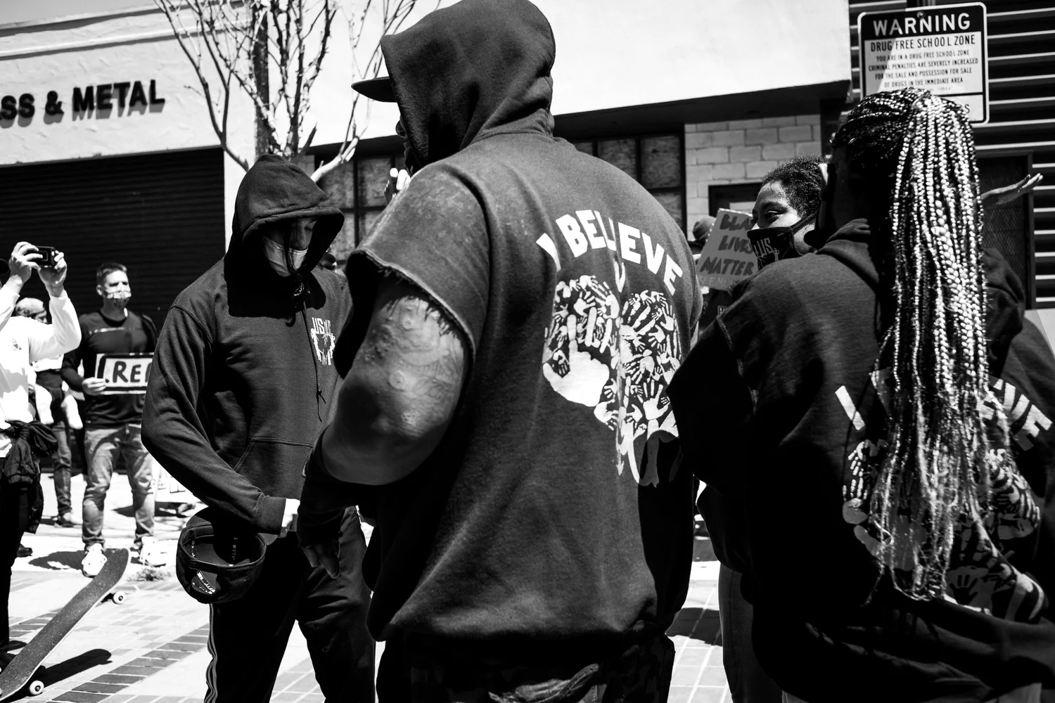Black-and-white view of rally participants standing together.