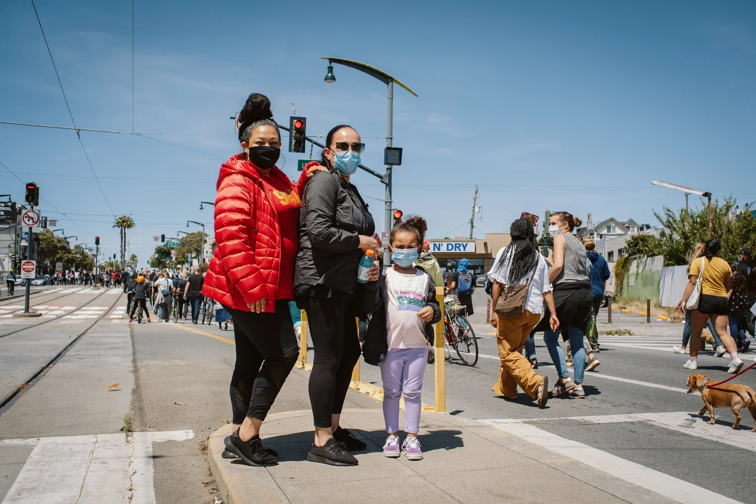 Two adults and a child standing together at the march.