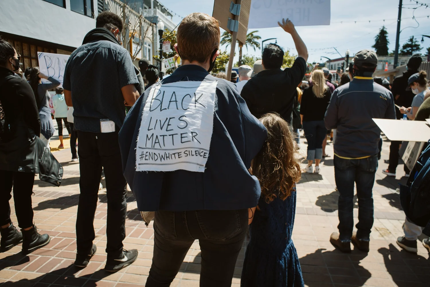 Participant wearing a handwritten Black Lives Matter sign on their back.