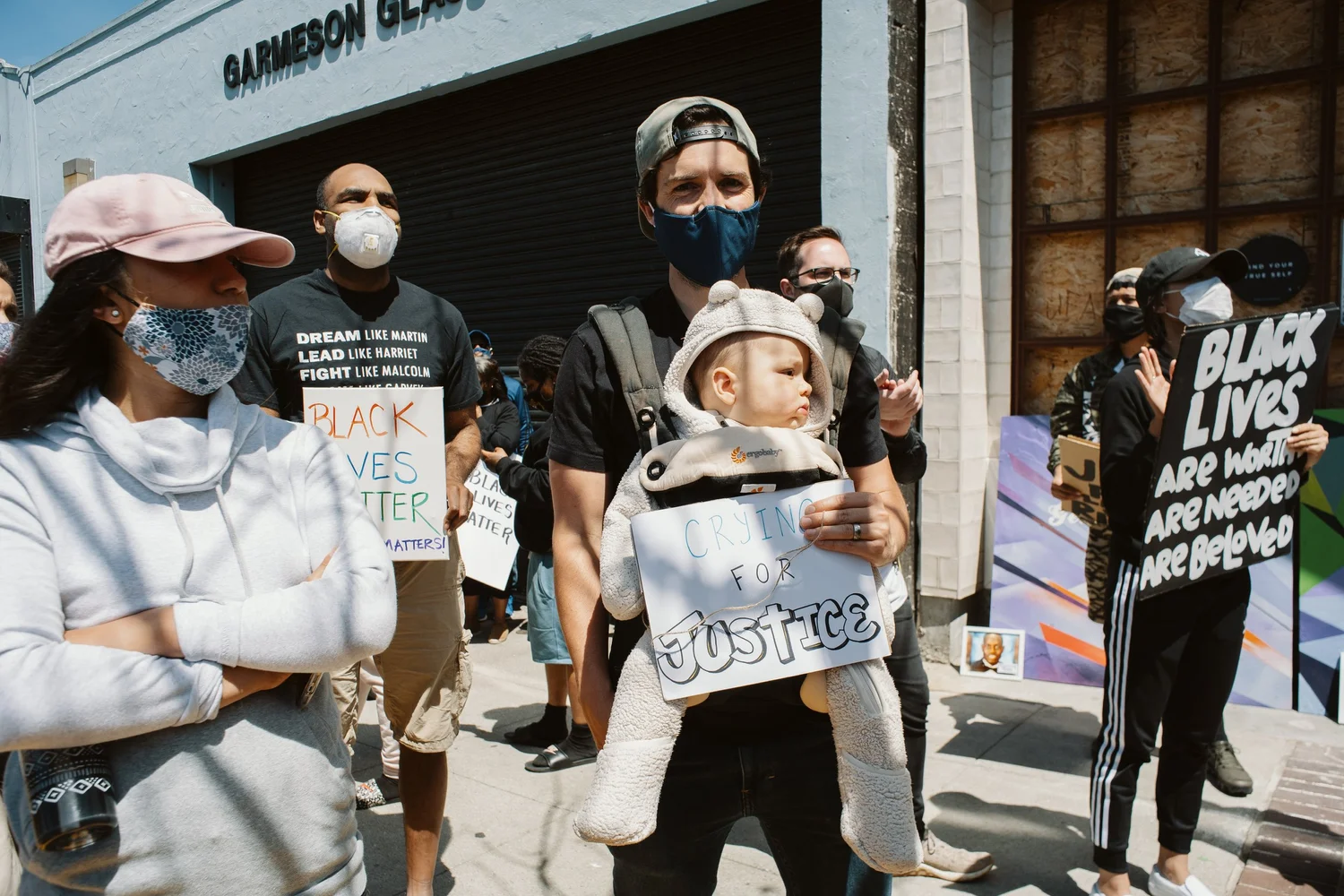 Participants with a child holding a Justice sign.