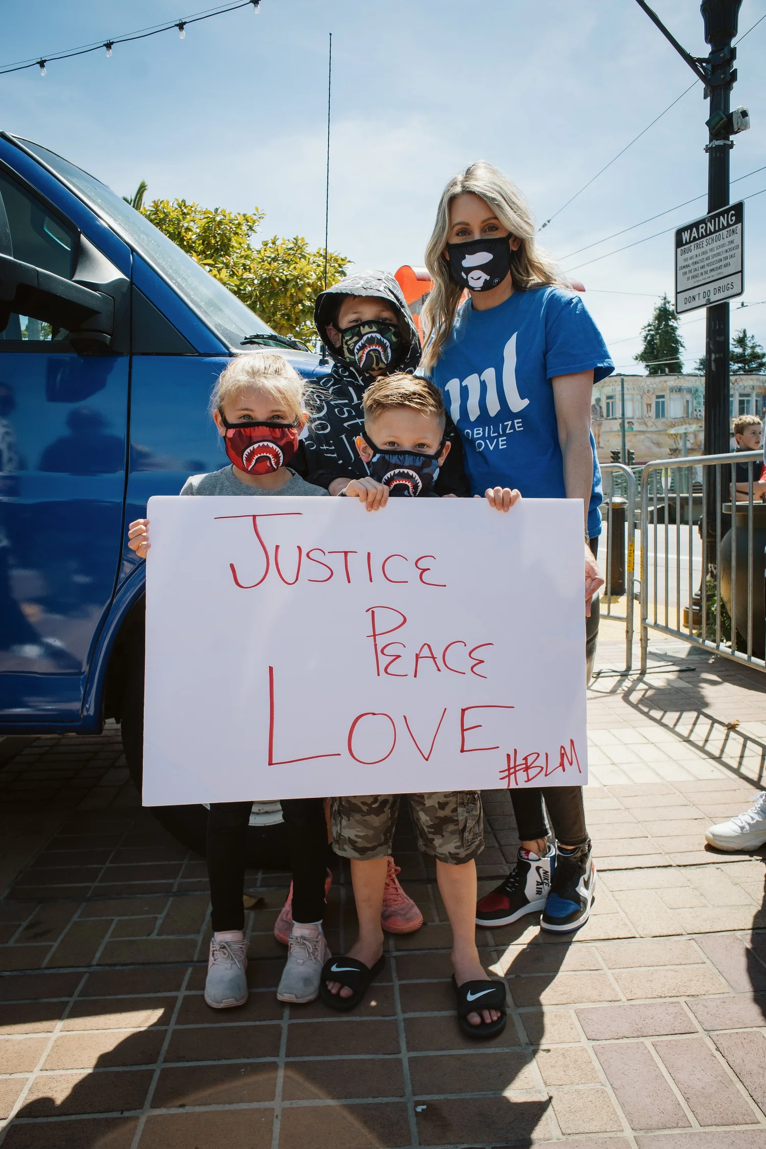 Family posing with a Justice, Peace, Love sign.