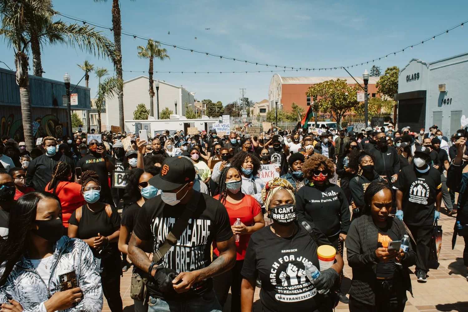 Large rally crowd assembled in a plaza.