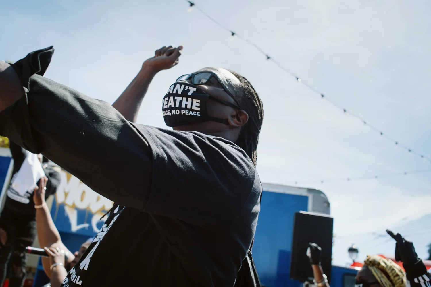 Participant raising an arm while wearing an I Can't Breathe mask.