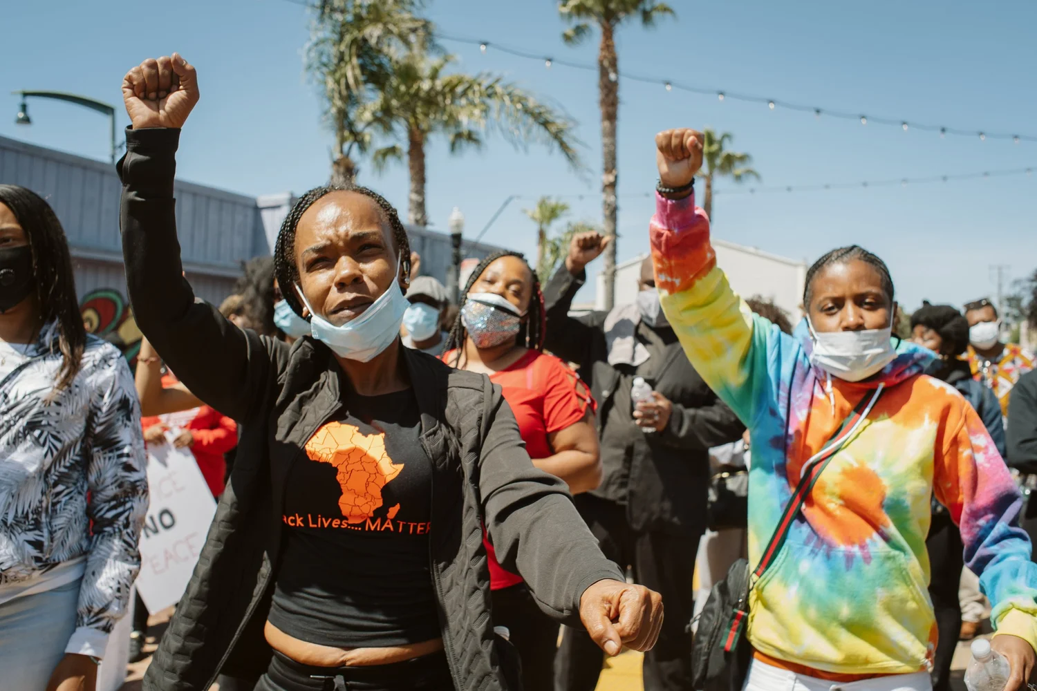 Close view of participants holding fists in the air.