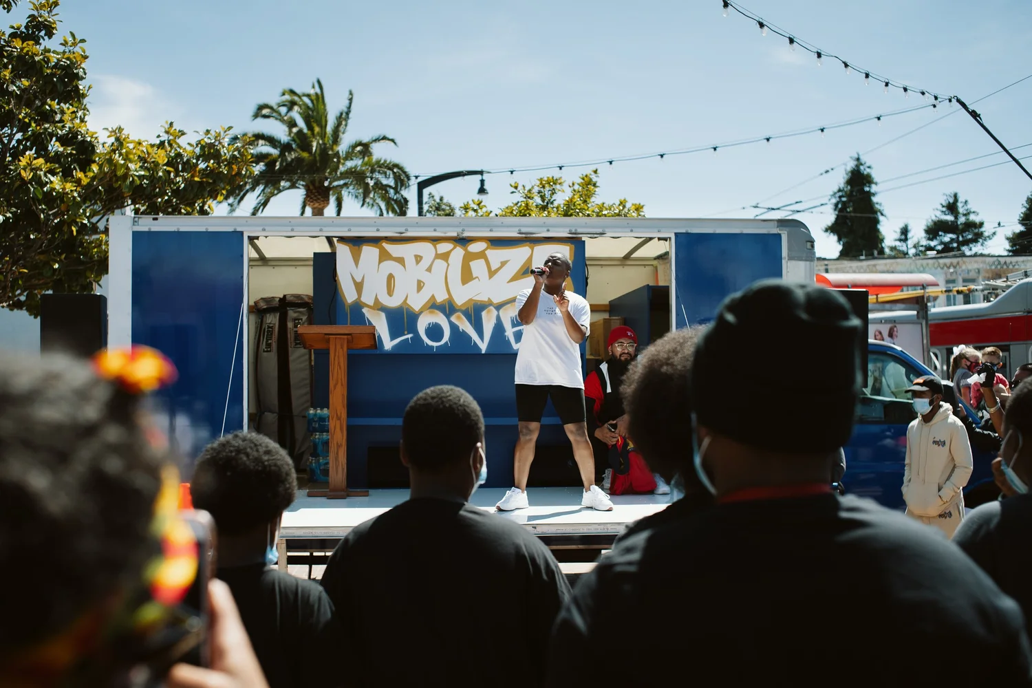 Performer in a white shirt addressing the crowd.