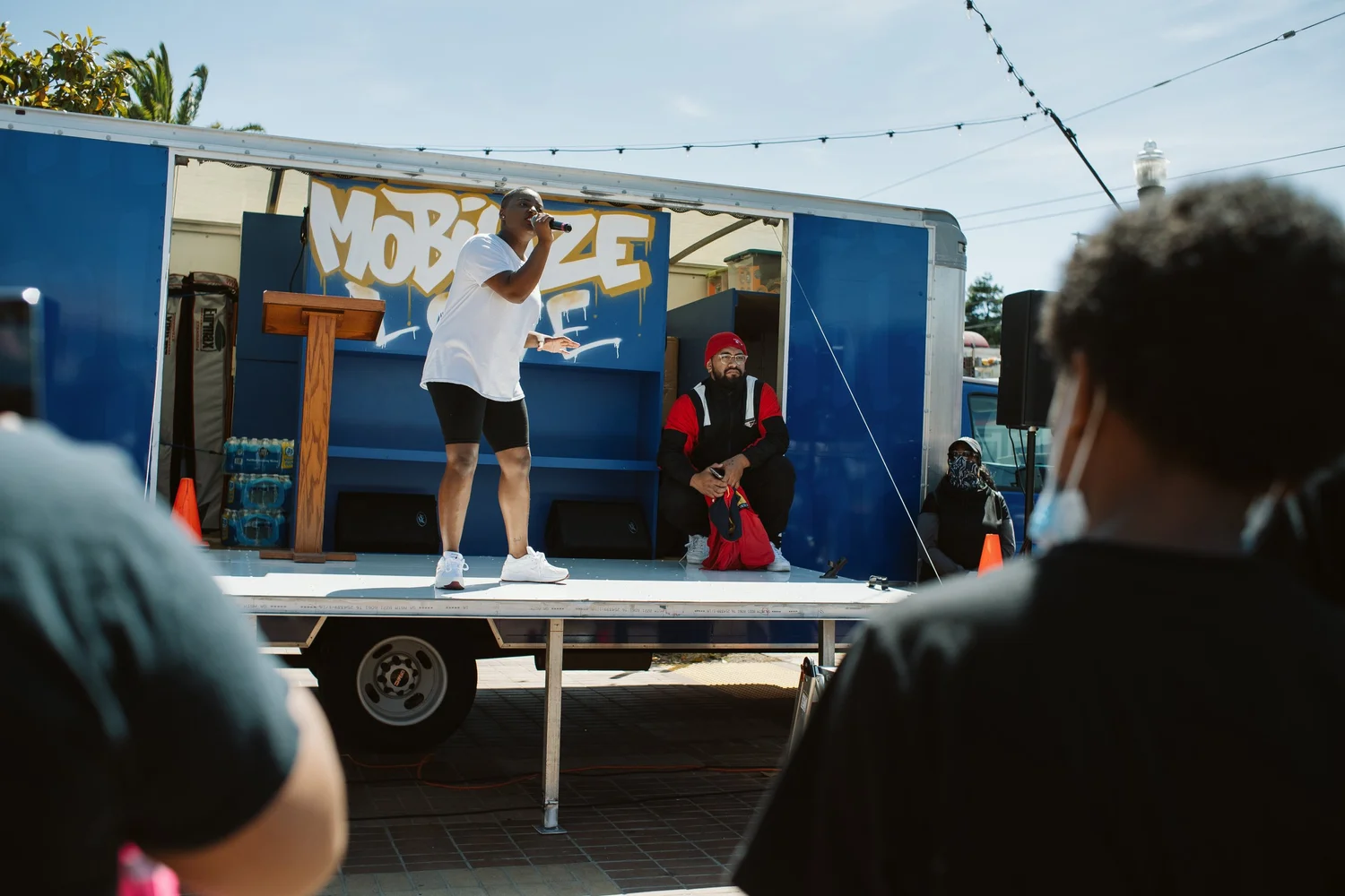 Performer raising an arm while holding a microphone.