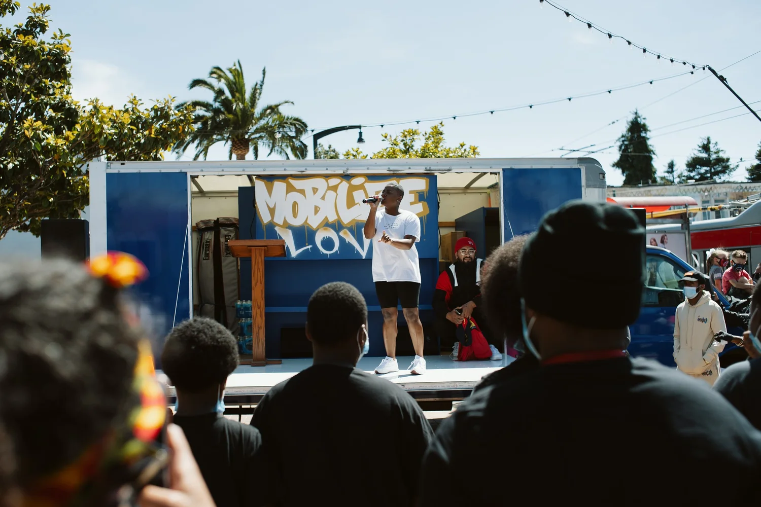 Performer standing beside a lectern on the truck stage.