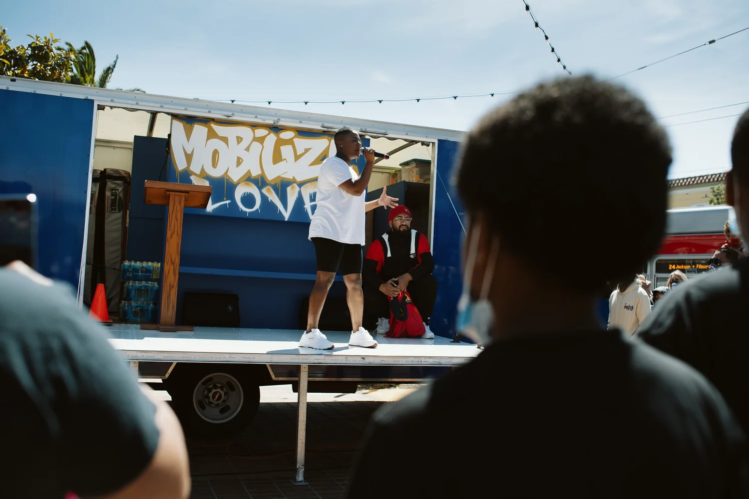 Performer facing the crowd from the truck stage.