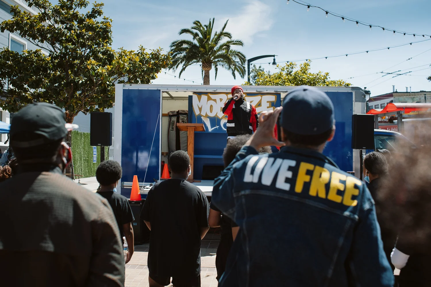 View past an attendee's Live Free shirt toward the speaker.