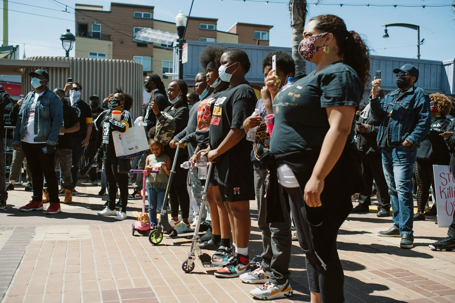 Participants standing in a line facing the stage.