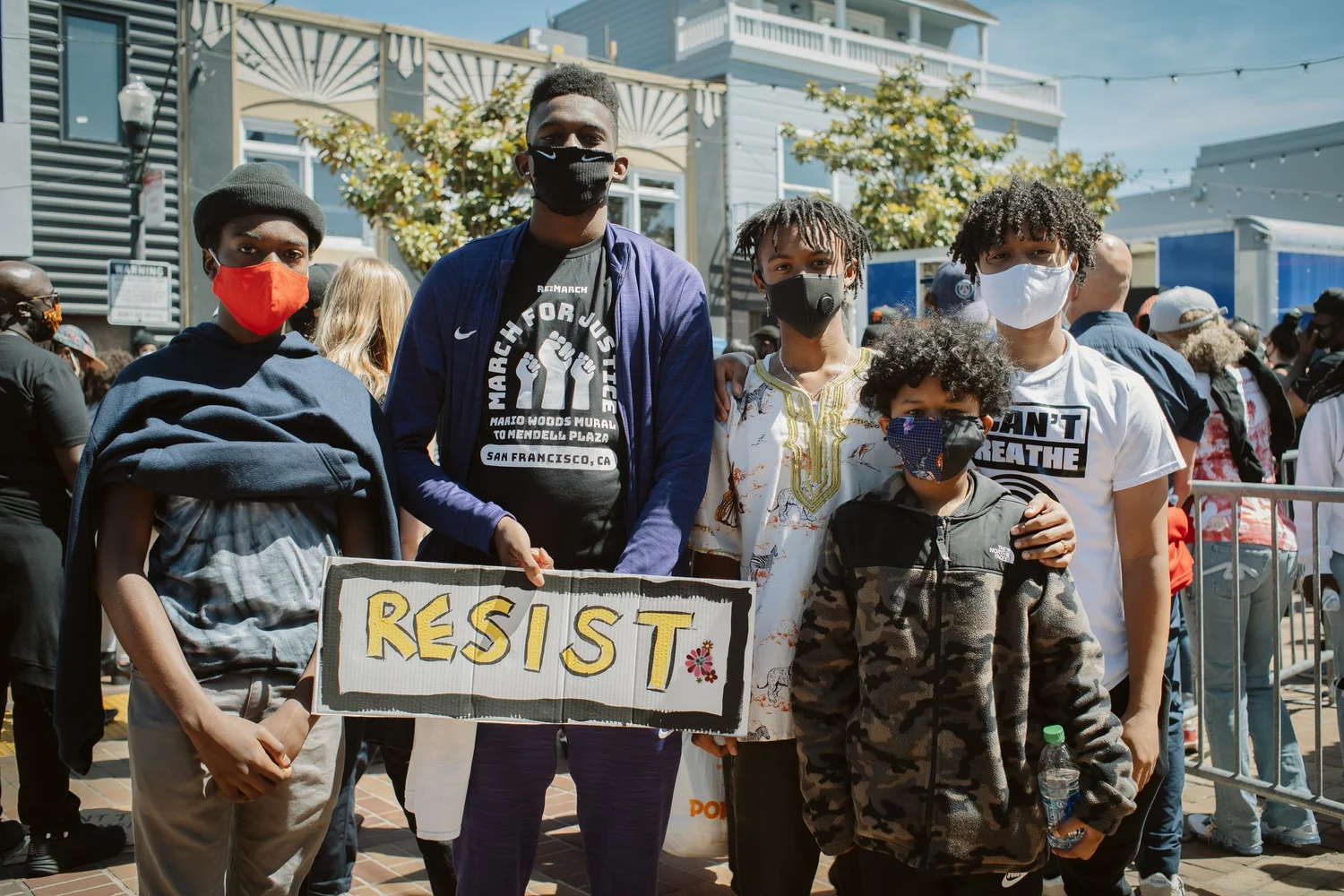 Group posing with a Resist sign.