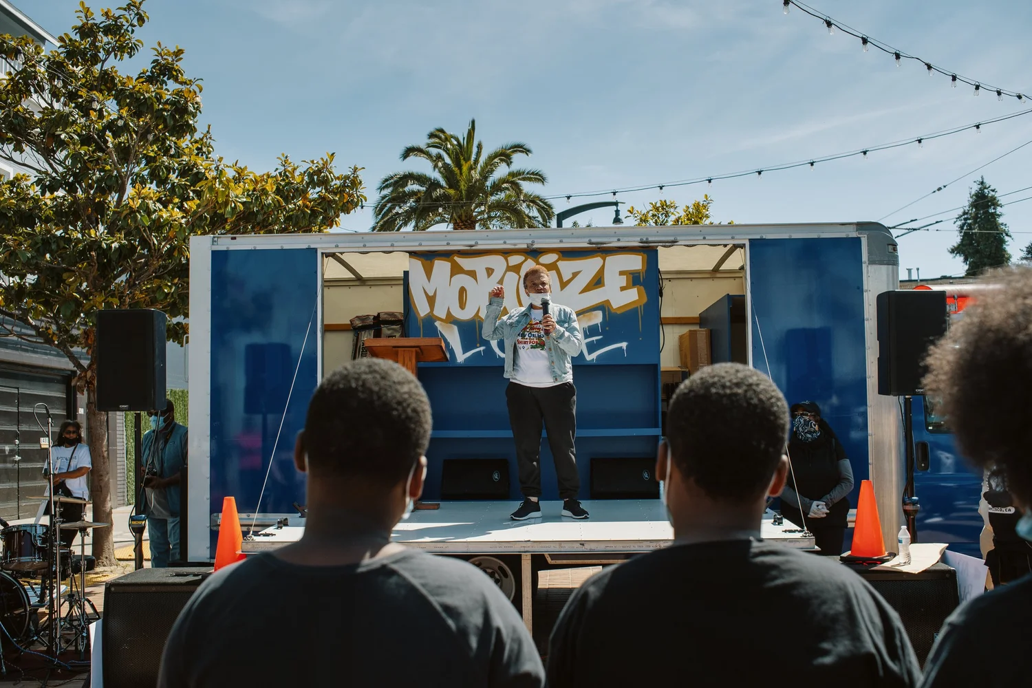 Audience facing a speaker on the truck stage.