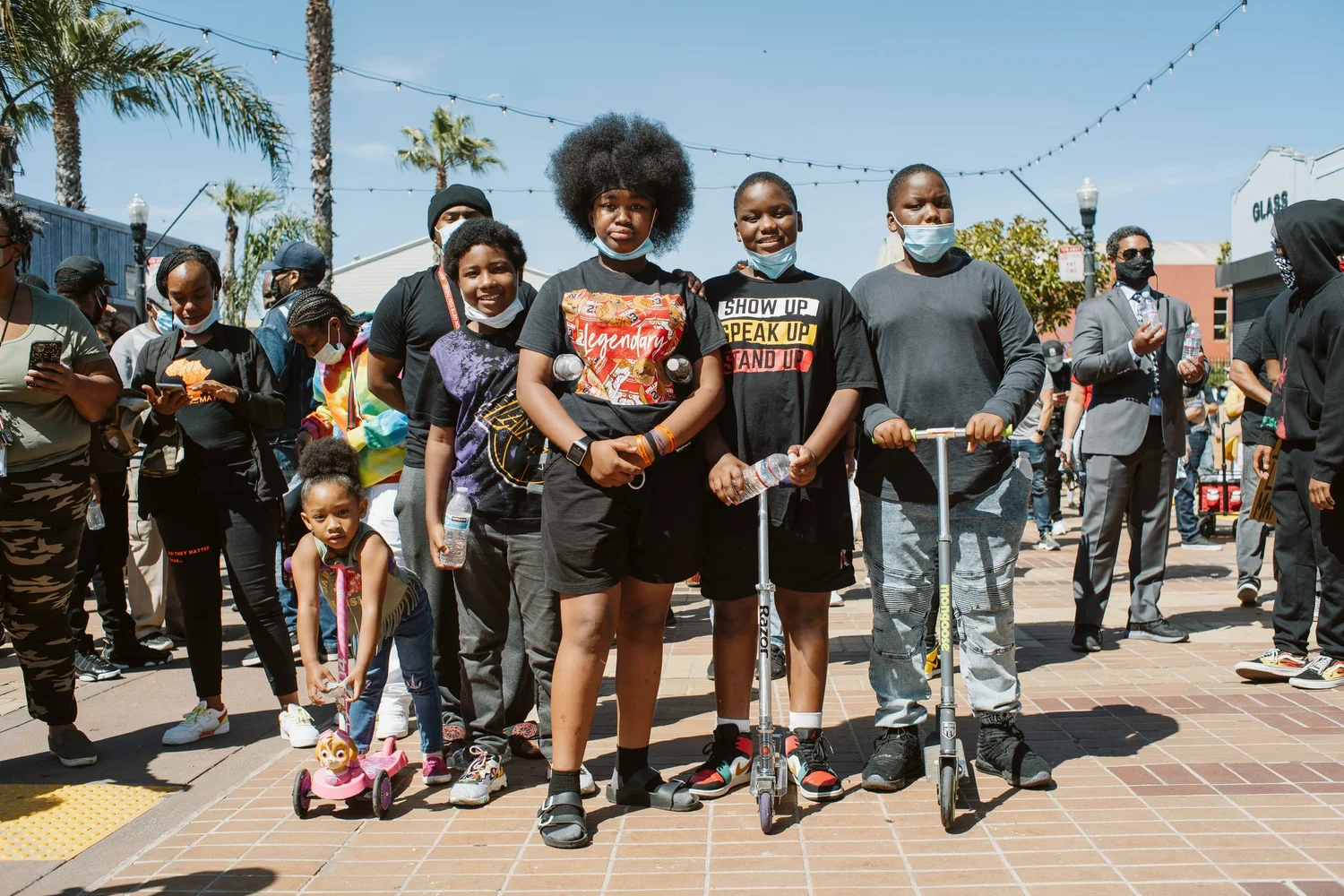 Group of children and young people posing with scooters.