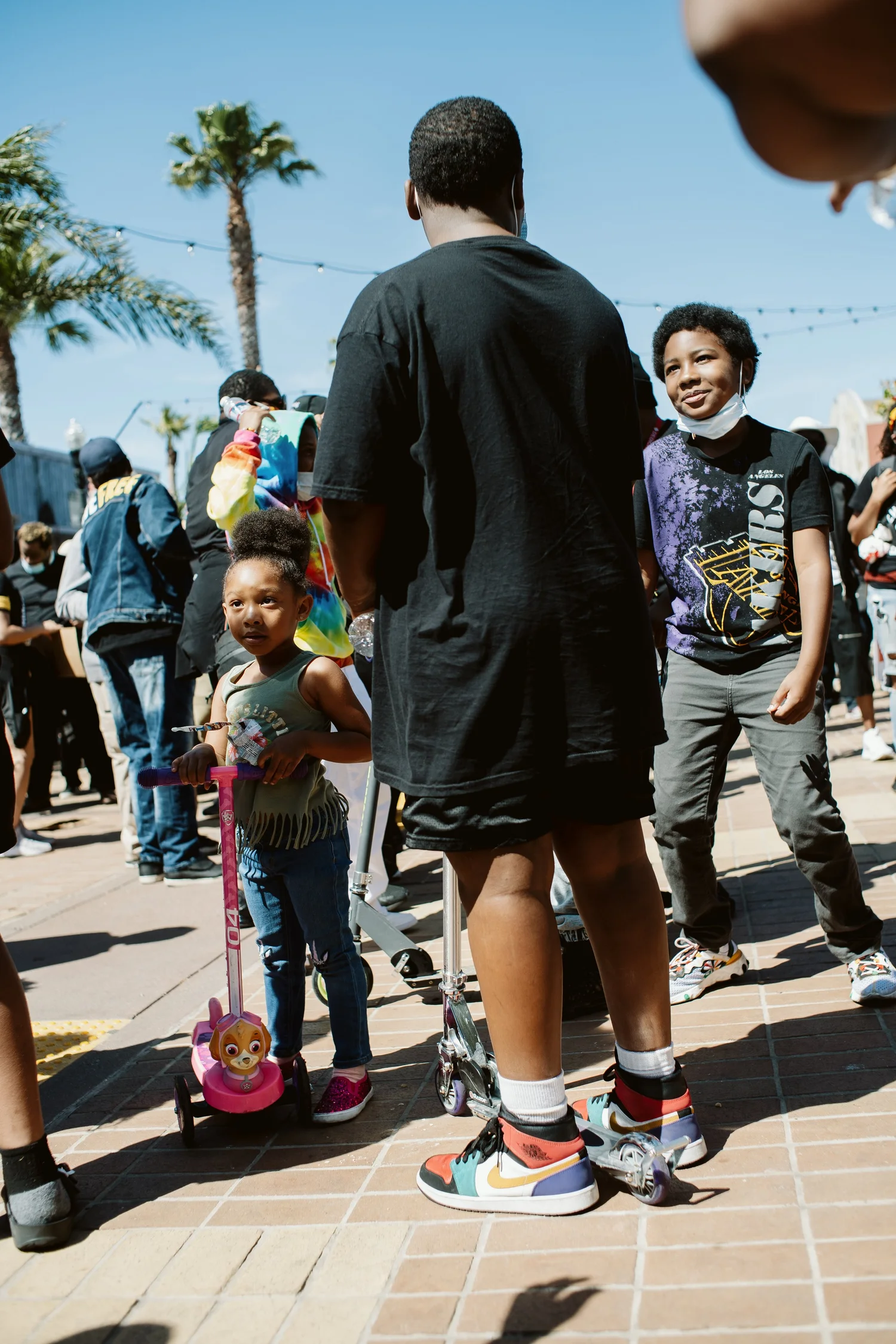 Young participants standing beside scooters.
