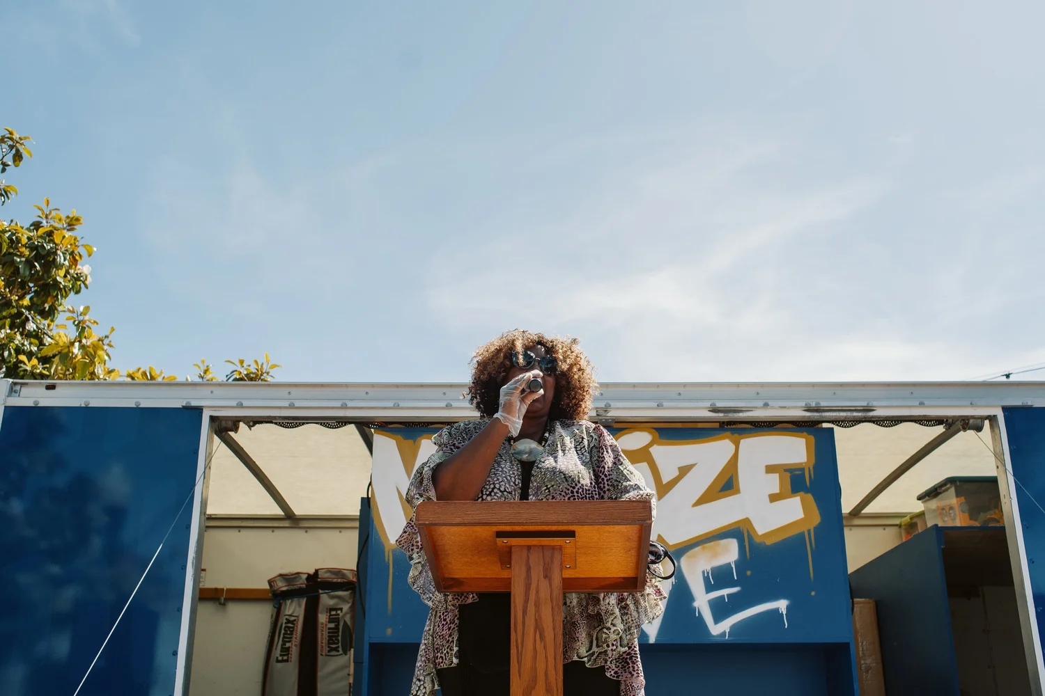 Speaker addressing the rally from a wooden lectern.
