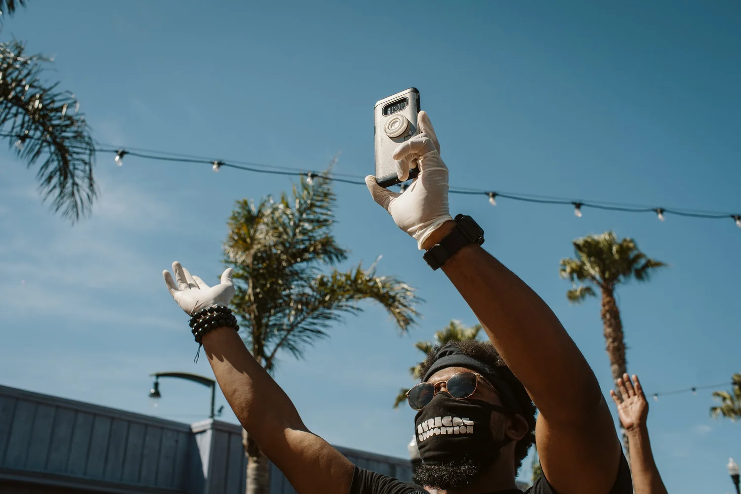 Participant lifting a phone toward the sky.