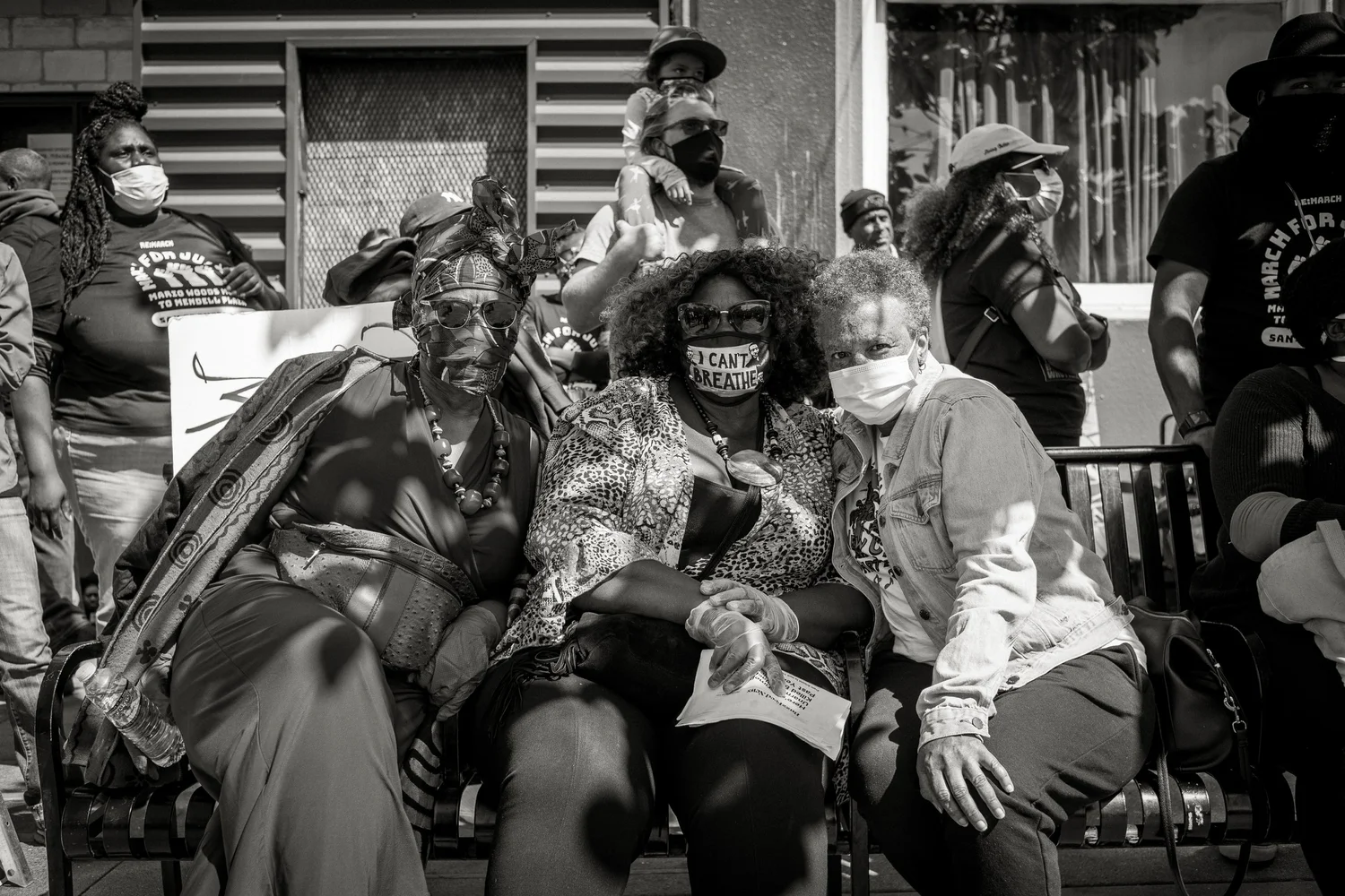 Black-and-white portrait of three seated participants.