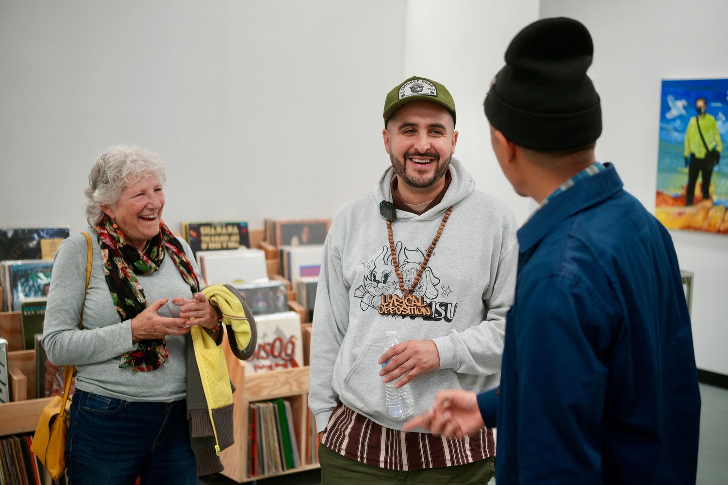 Visitors share a conversation beside vinyl records.