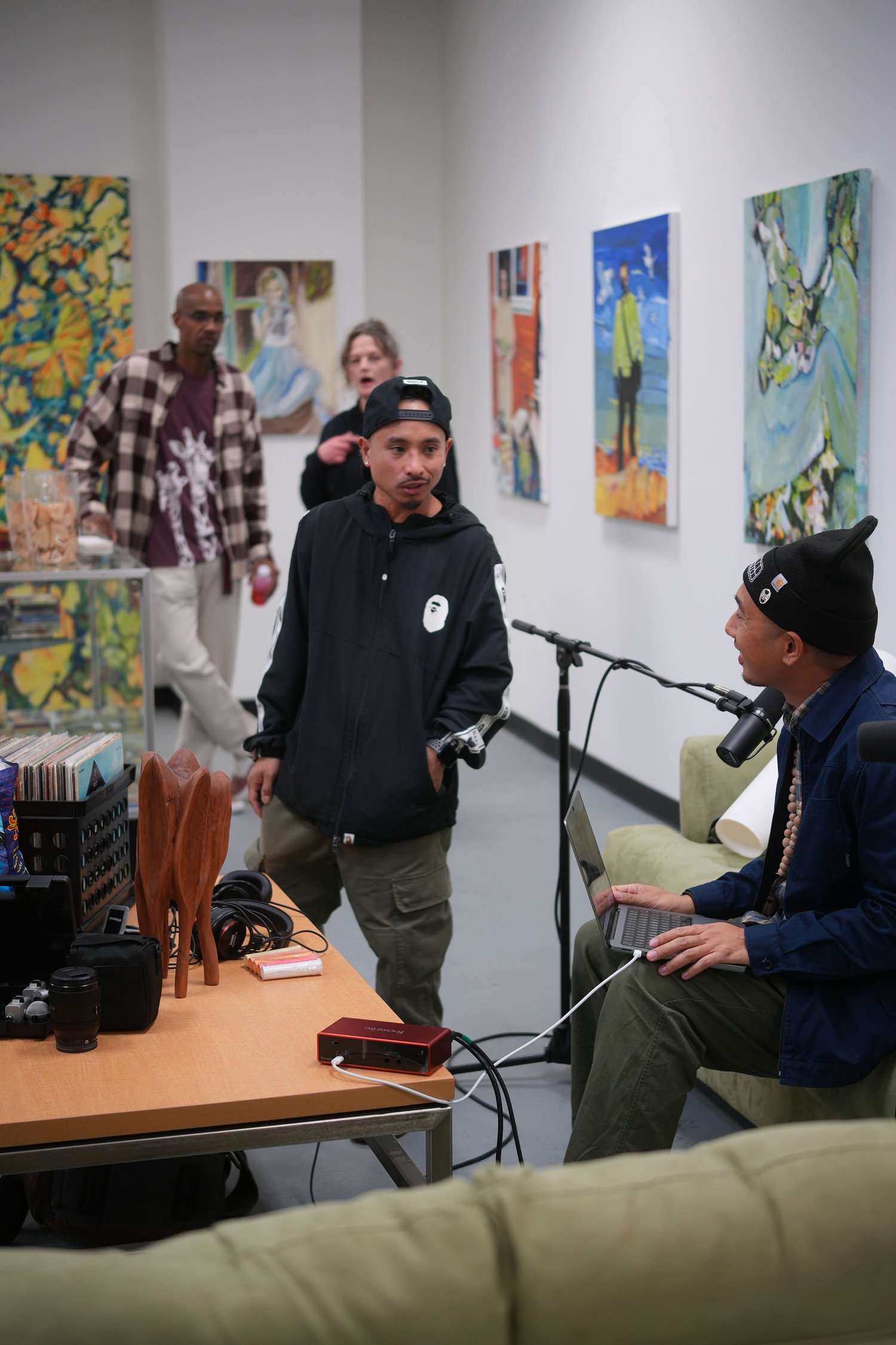 Guests gather beside a microphone and display table.