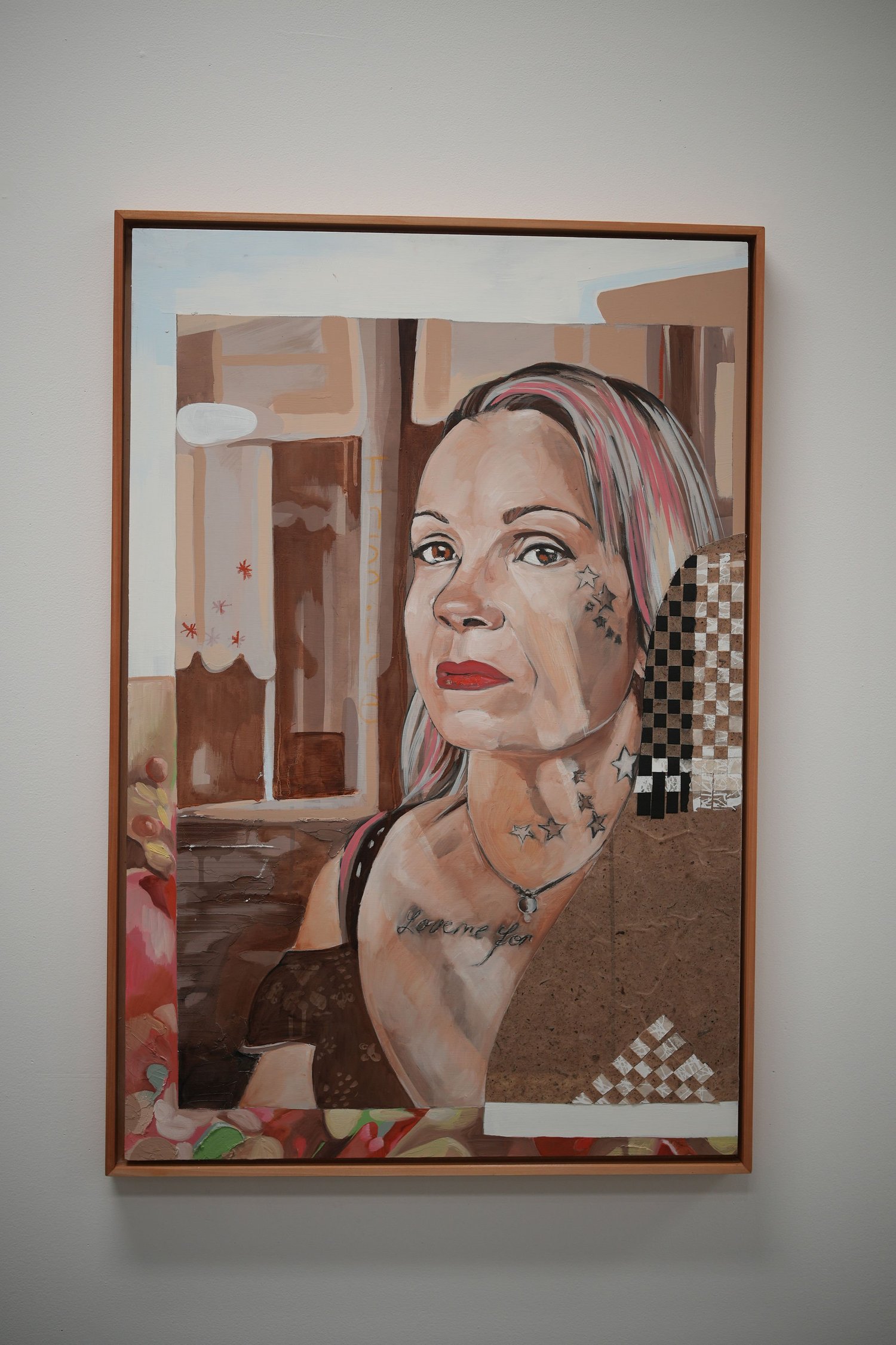 A framed painted portrait of a person looking sideways.