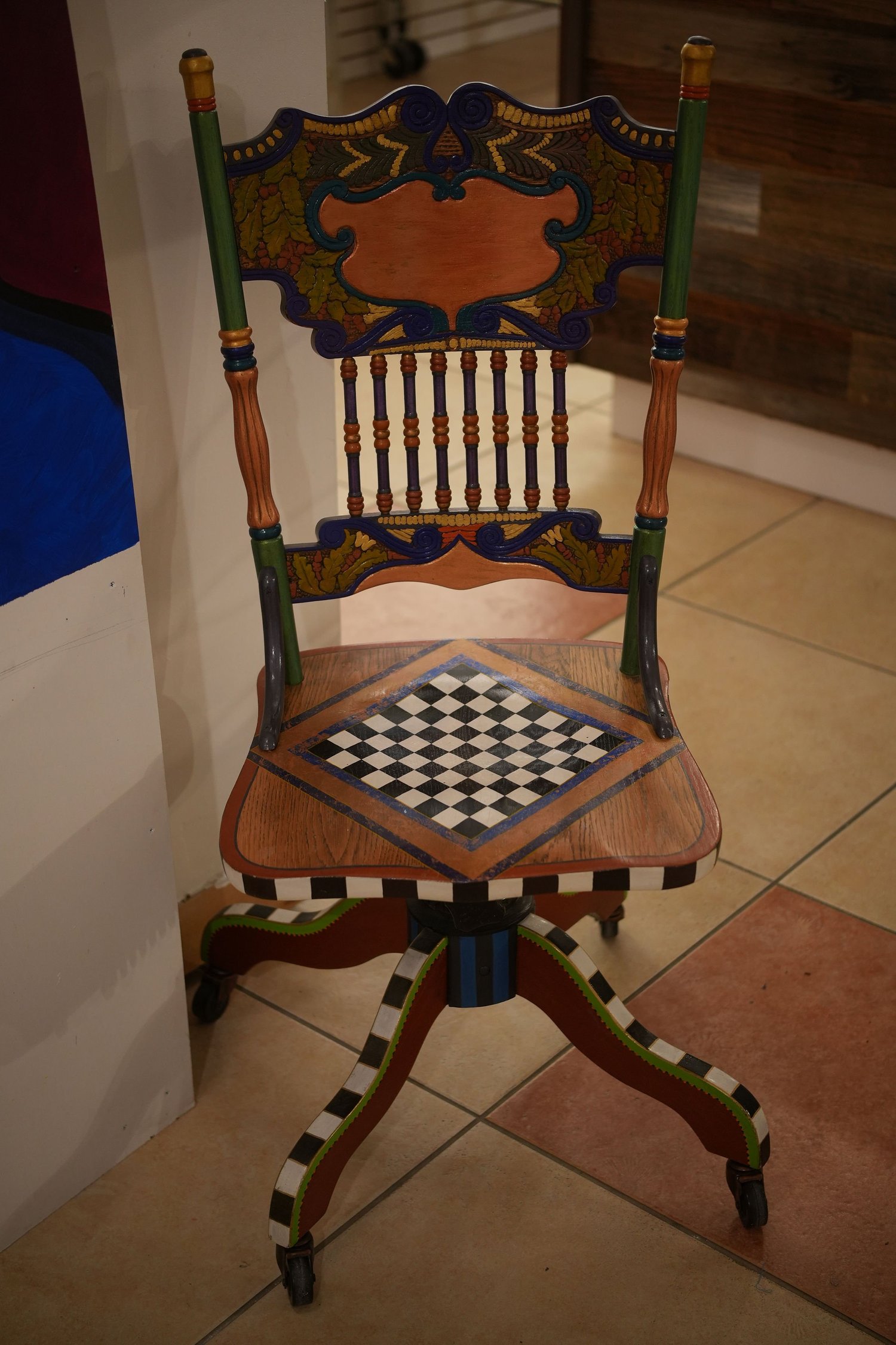A decorative wooden chair displayed as artwork.