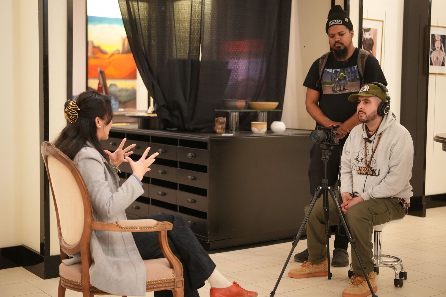An interviewer gestures during a recorded conversation.