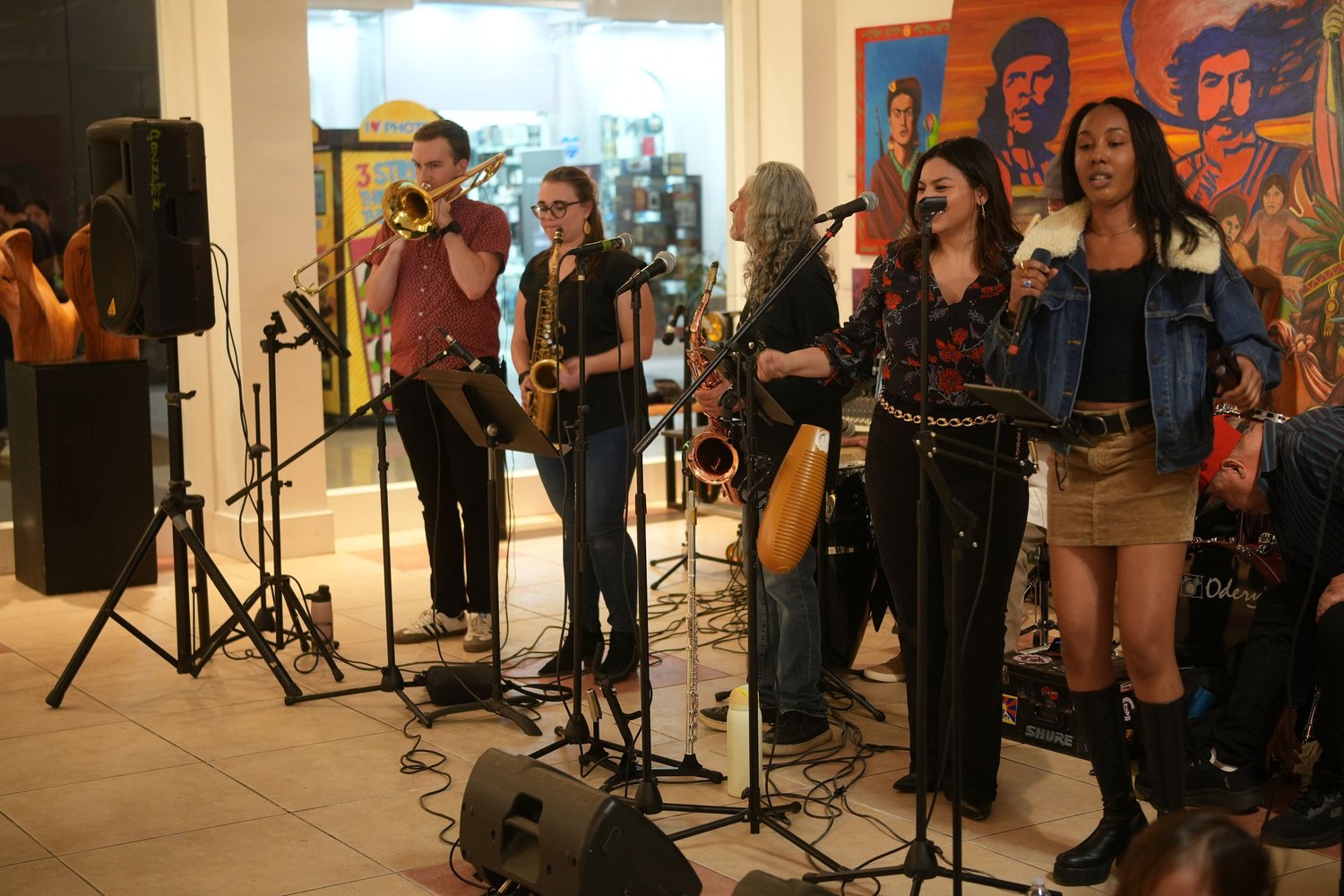 Vocalists and saxophonists perform together.