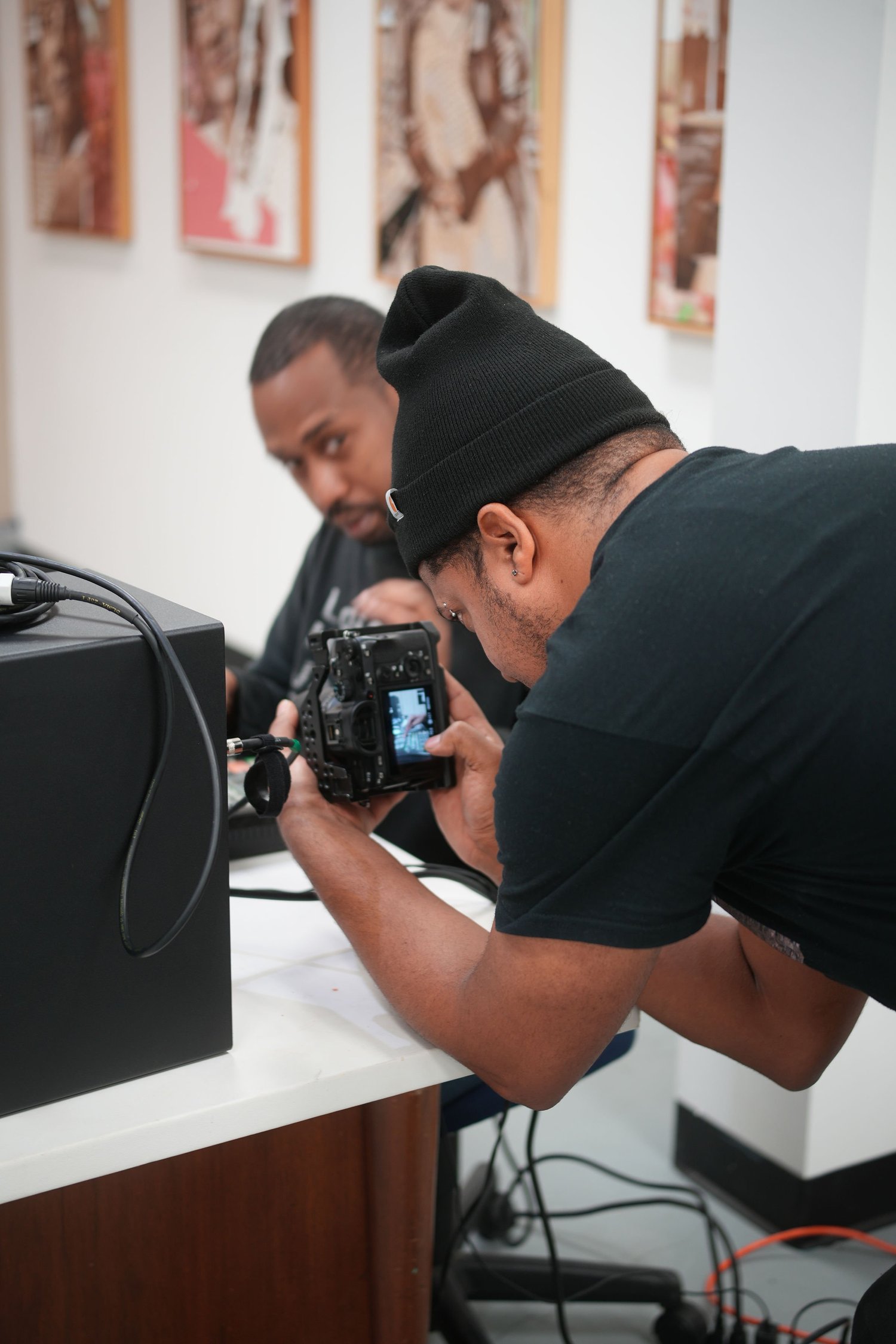 A camera operator films a DJ at work.