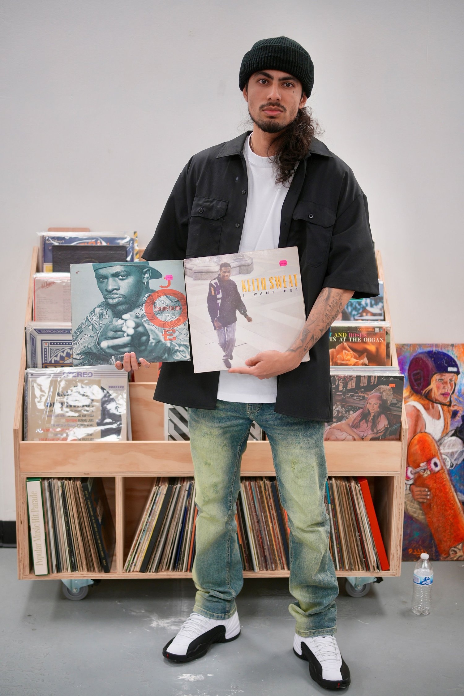 A visitor displays two vinyl record sleeves.