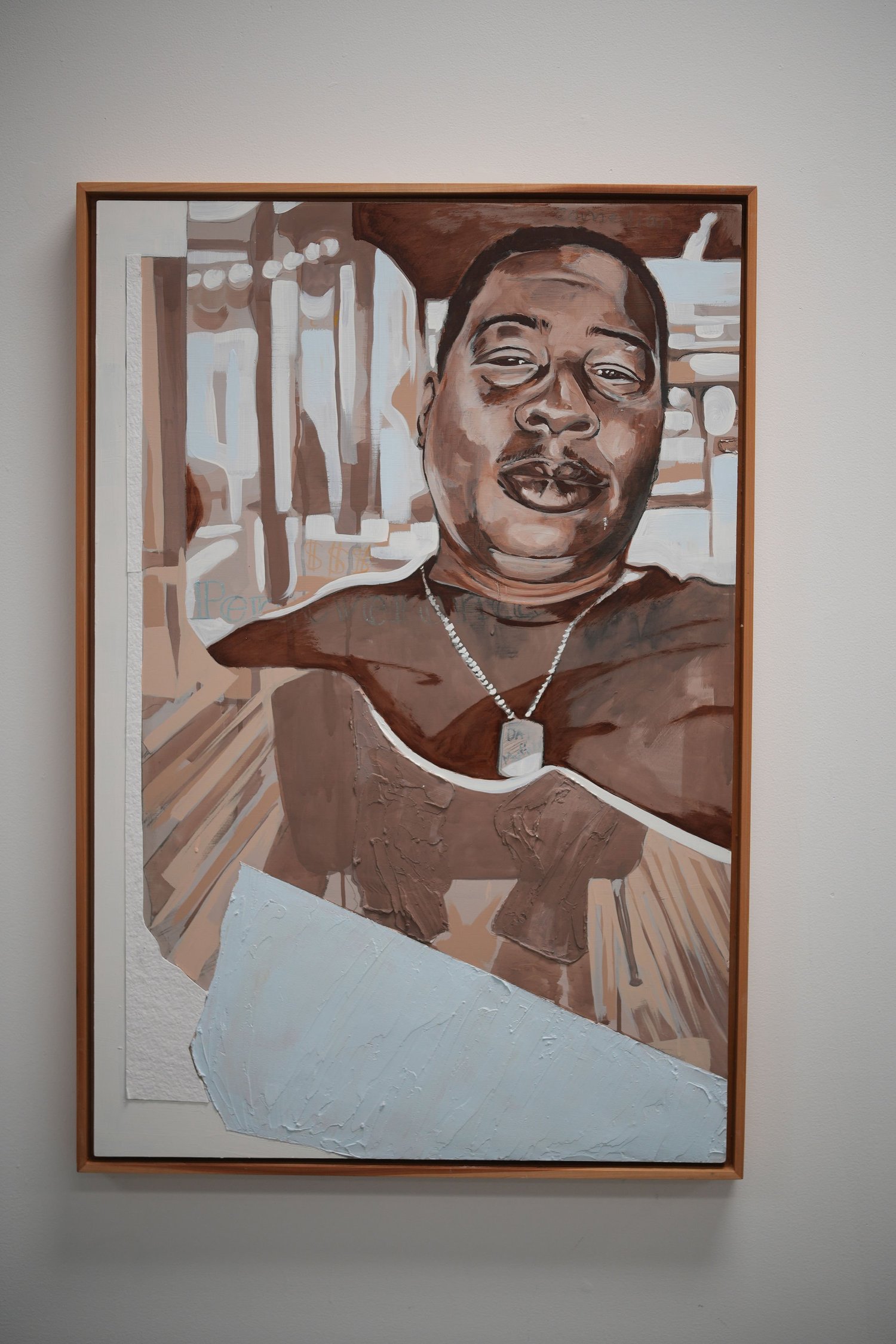 A framed portrait of a smiling person.
