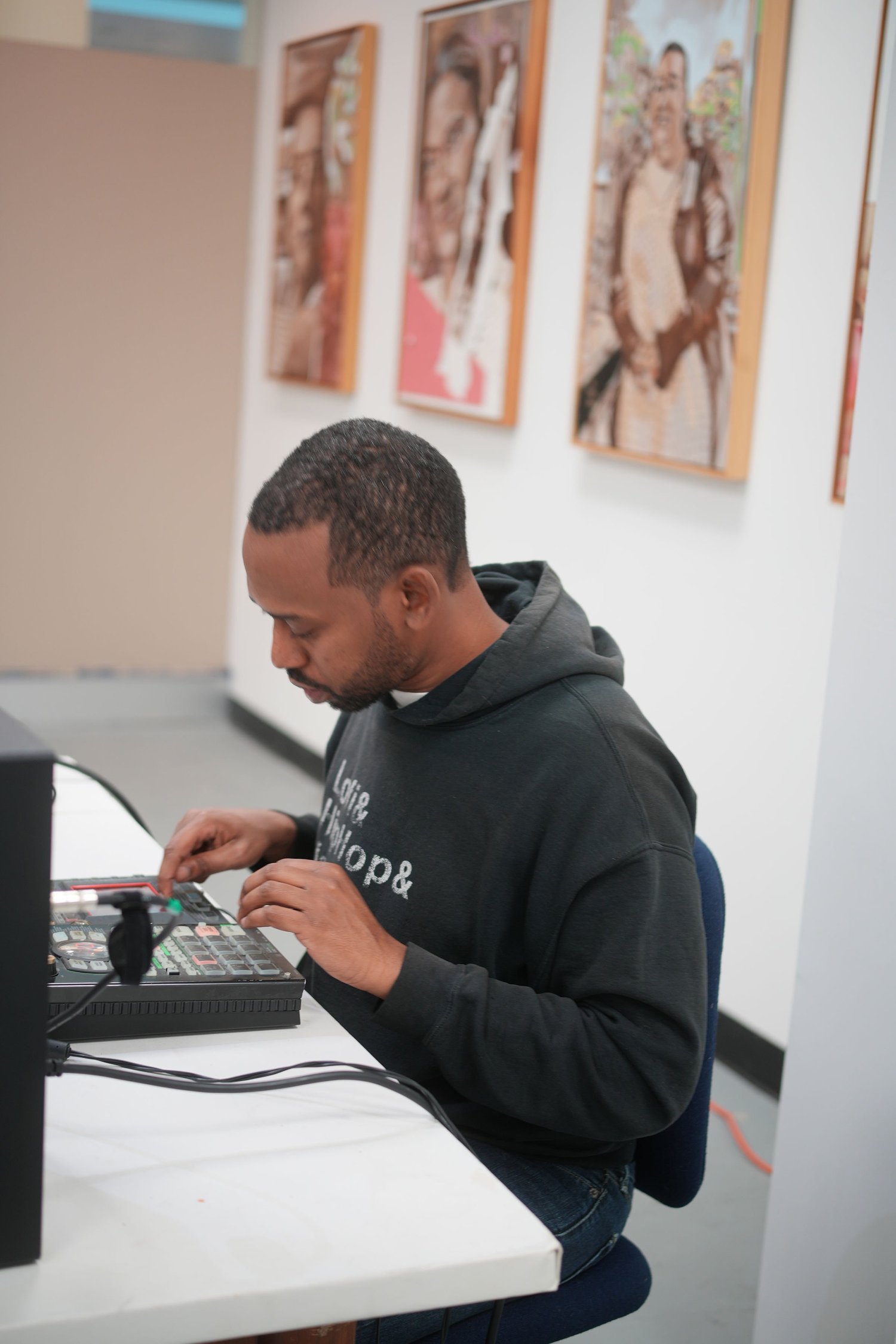 A DJ adjusts equipment at a table.