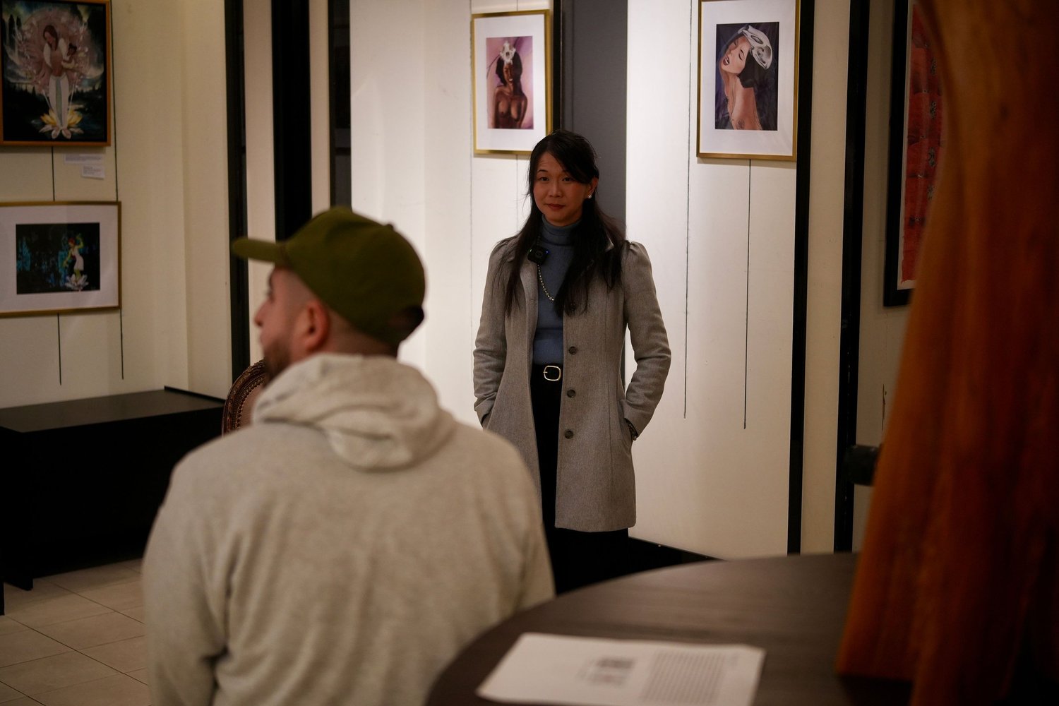 An interviewer and guest talk in the exhibition space.