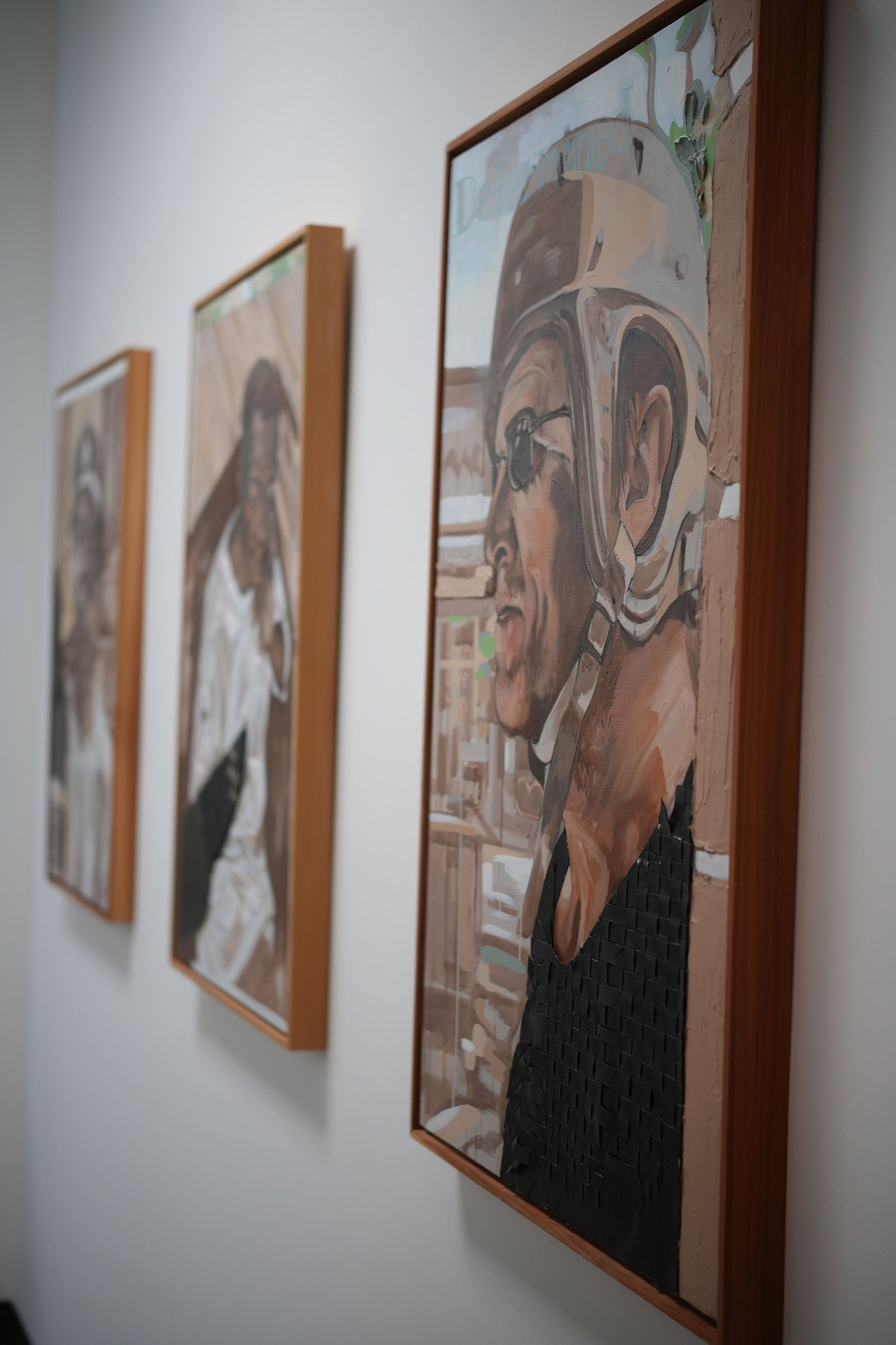 Close view of framed painted portraits.