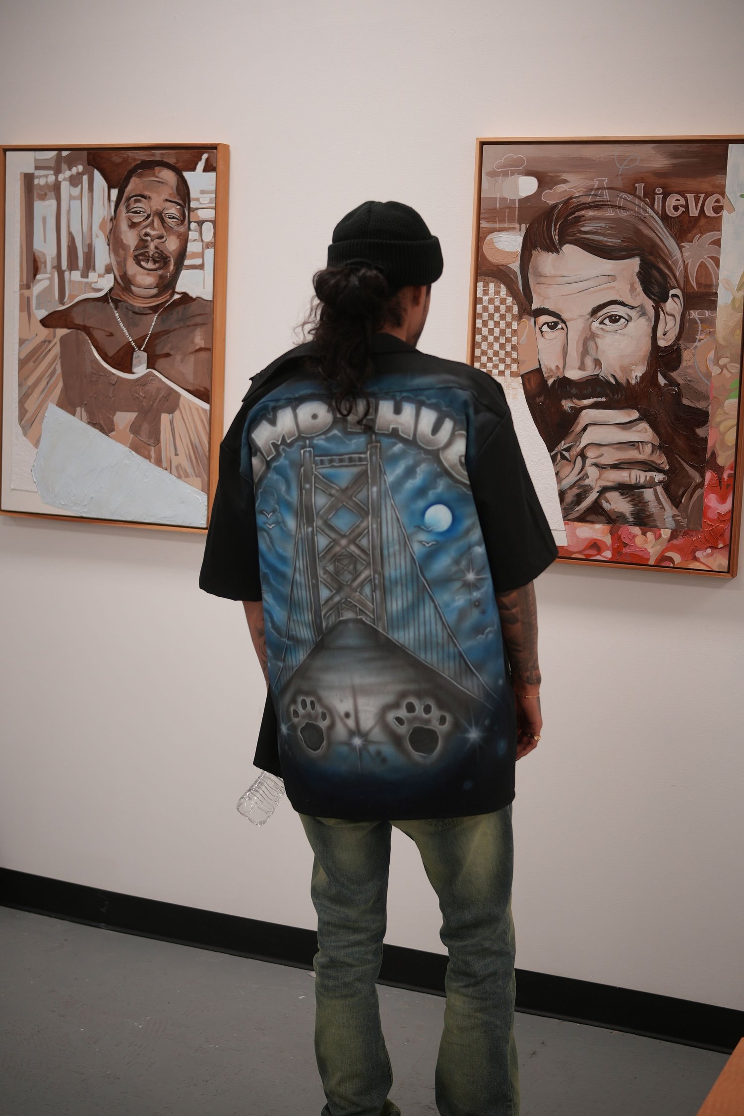 A visitor studies the framed portraits.