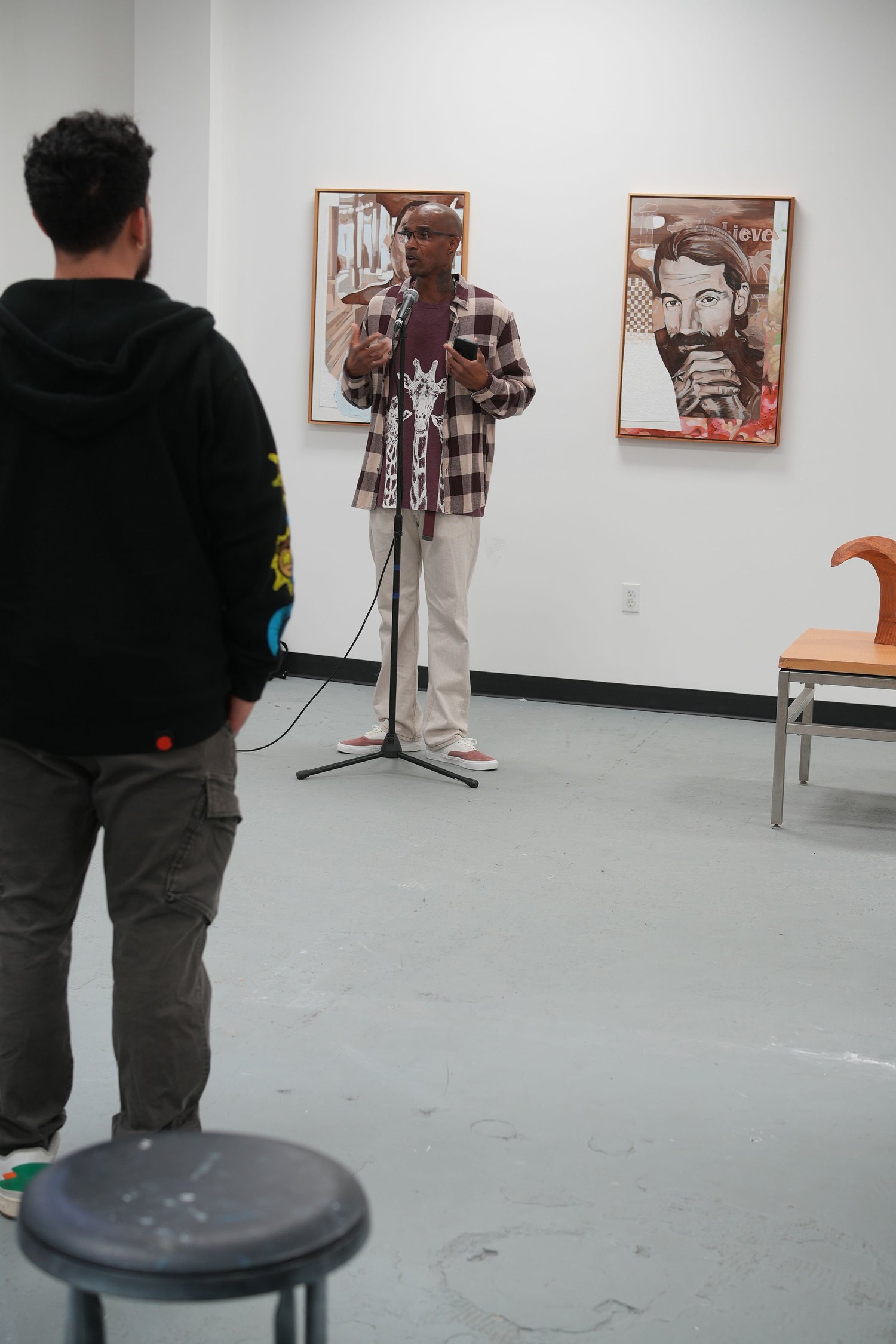 A photographer records a speaker at the microphone.