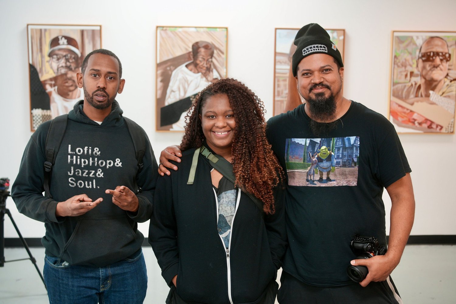 Three guests smile for a gallery portrait.