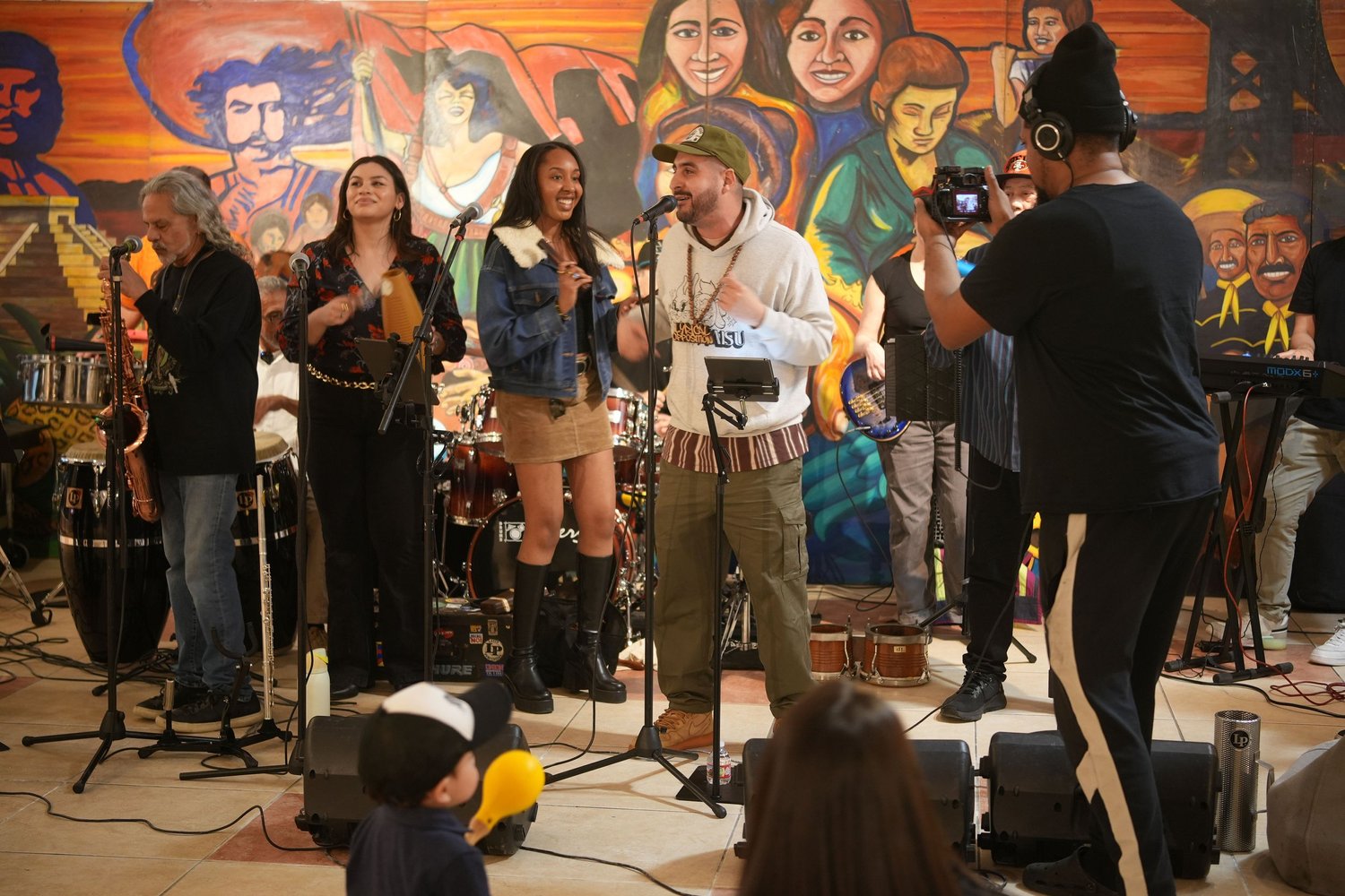 A camera operator films the band.
