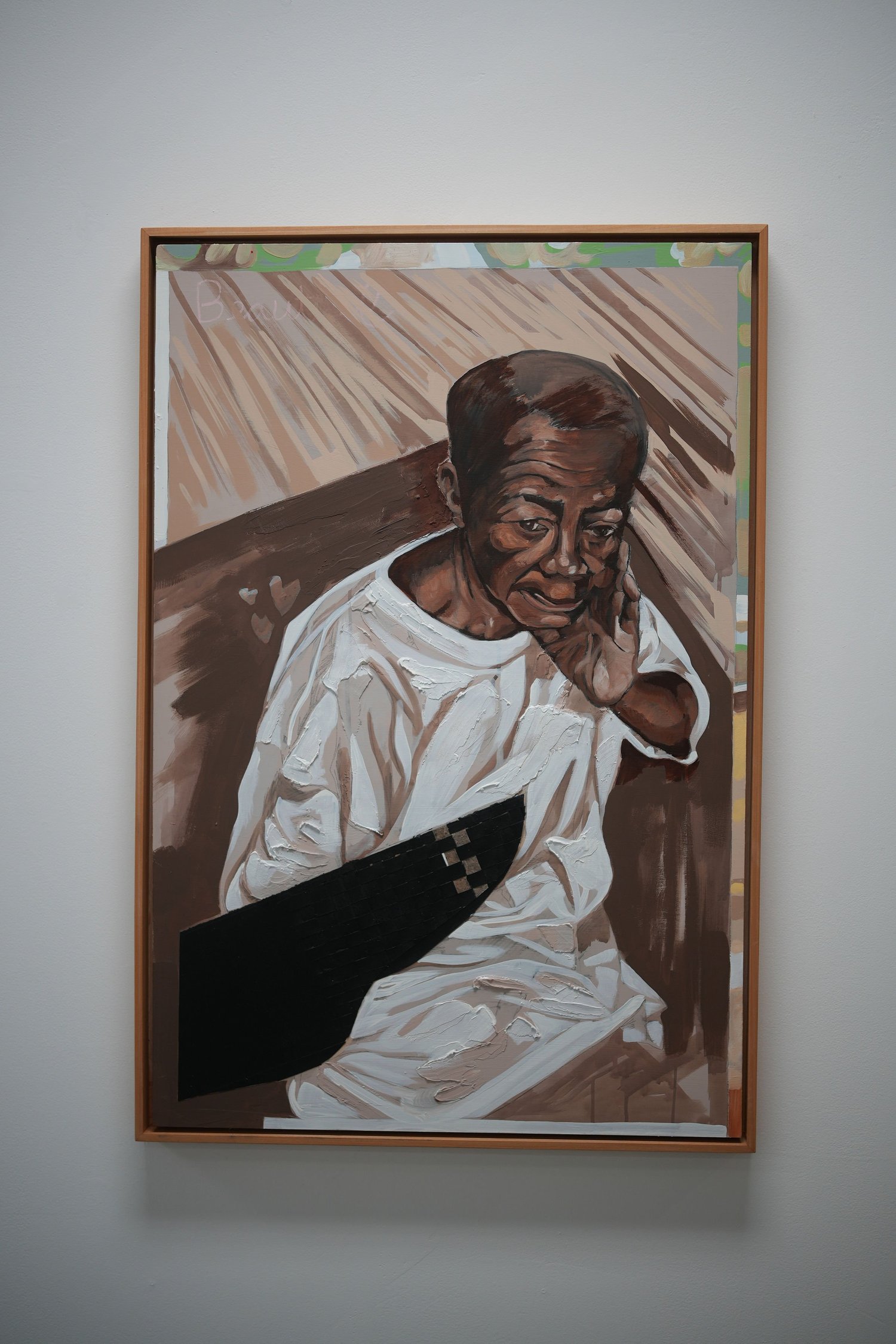 A framed portrait of a person holding a microphone.
