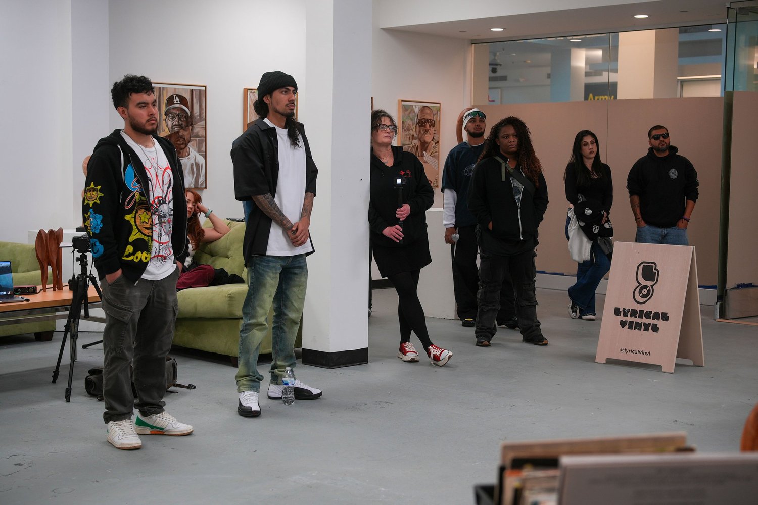 Guests stand together beside the Lyrical Vinyl sign.