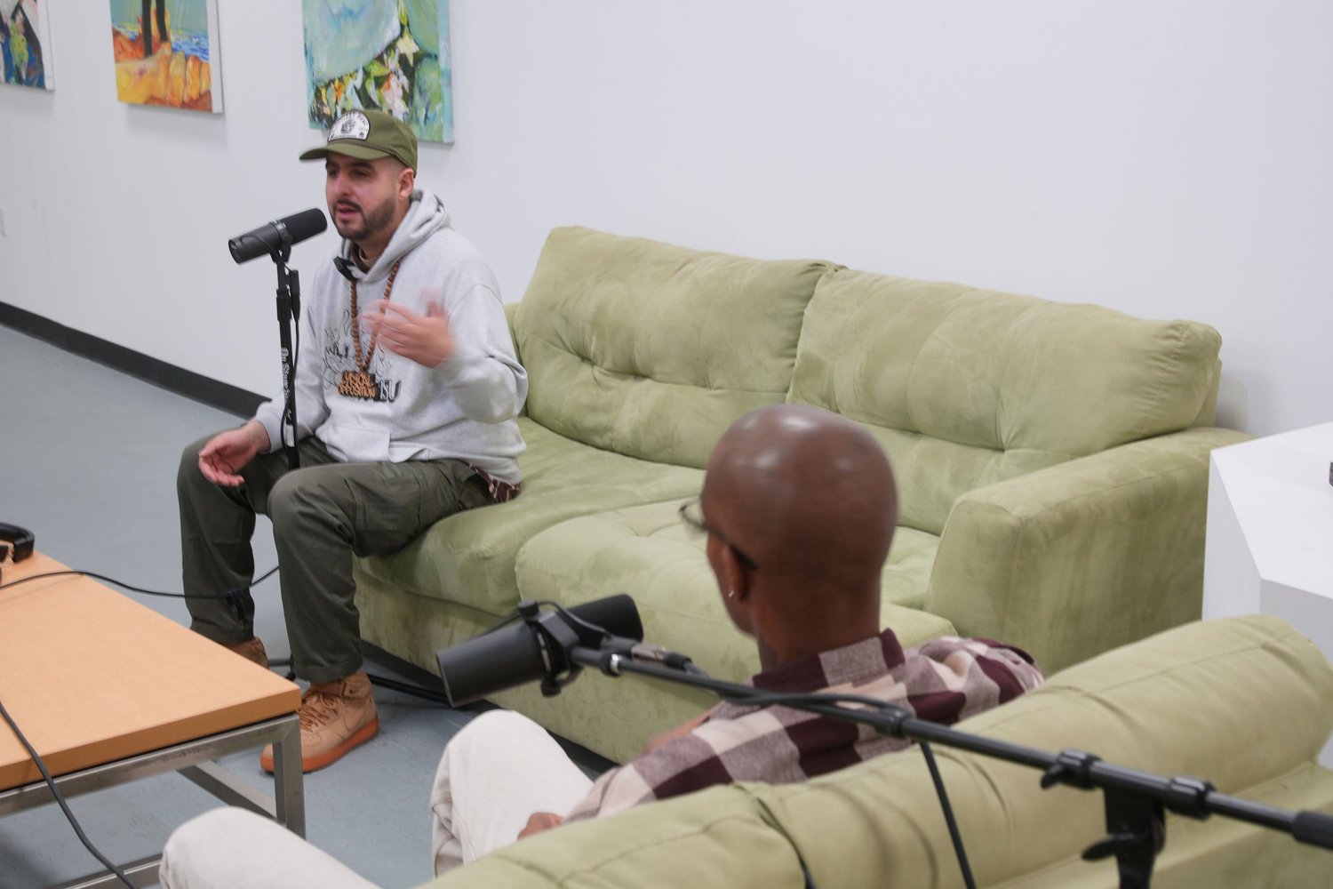 A participant speaks during a recorded conversation in the gallery.